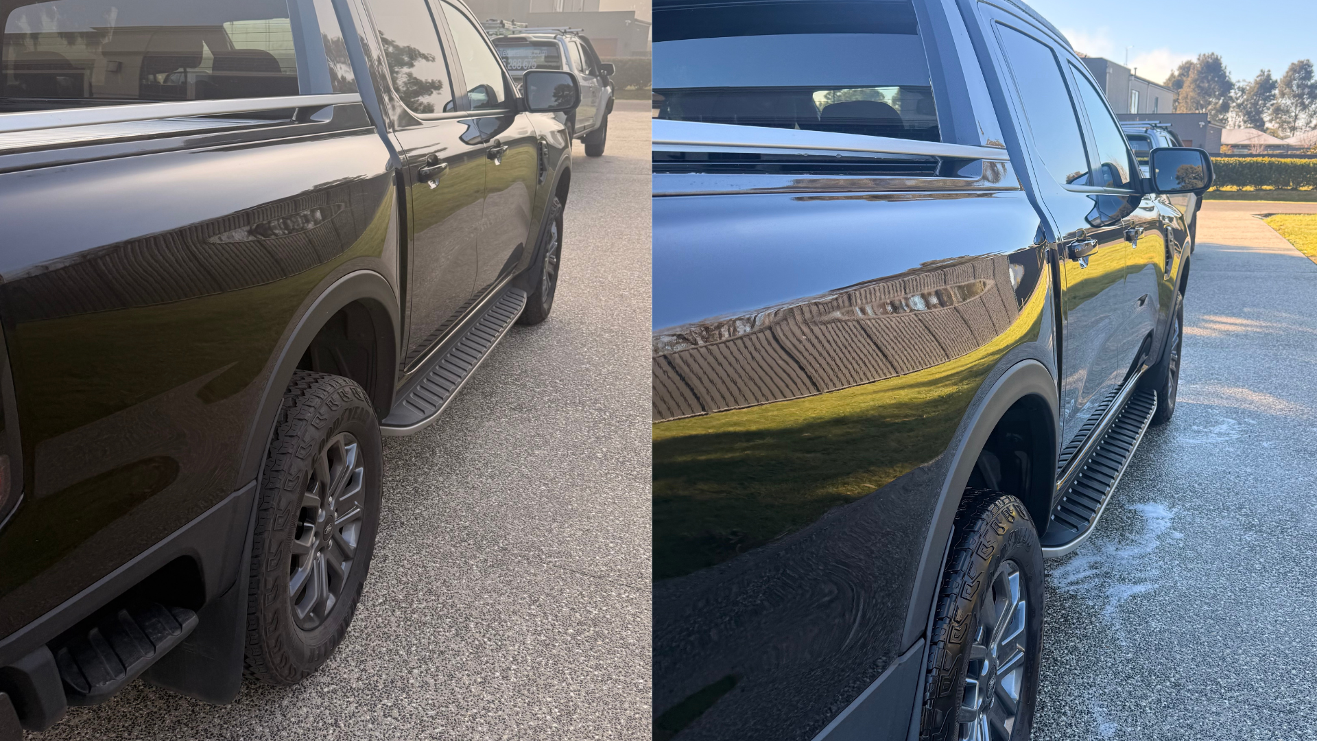 Side view of a black pickup truck parked outdoors, showing its side mirror, door handles, wheels, and side step, with a reflection of the surroundings on the body of the truck.