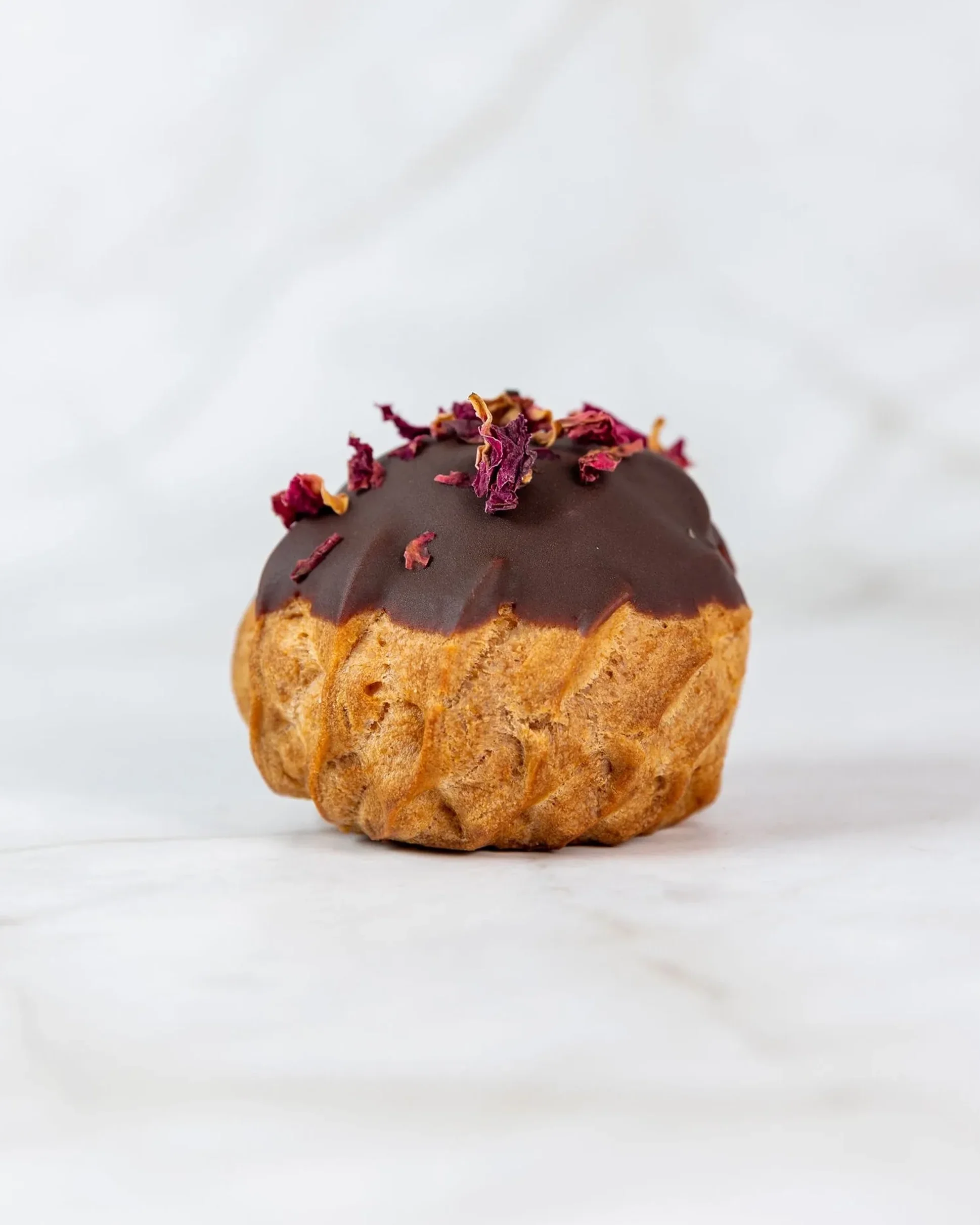 Eclair_at_the_bay_chocolate_glazed_choux_rose_petals_single.webp