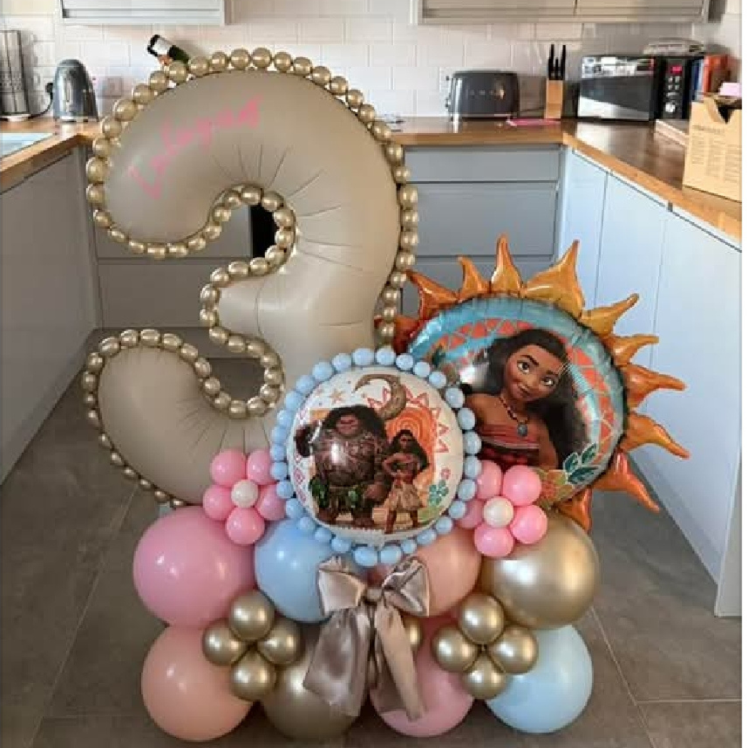 Colorful balloon display featuring Moana-themed images and decorations, including a large number two, representing a second birthday celebration.