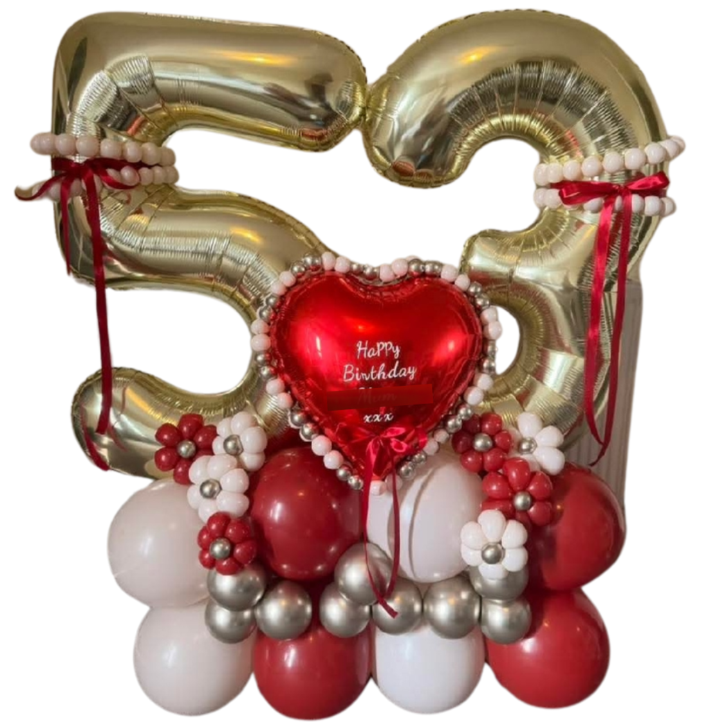 Balloon arrangement with large gold number 50, red, white, and silver balloons, and a red heart-shaped balloon with a birthday message.