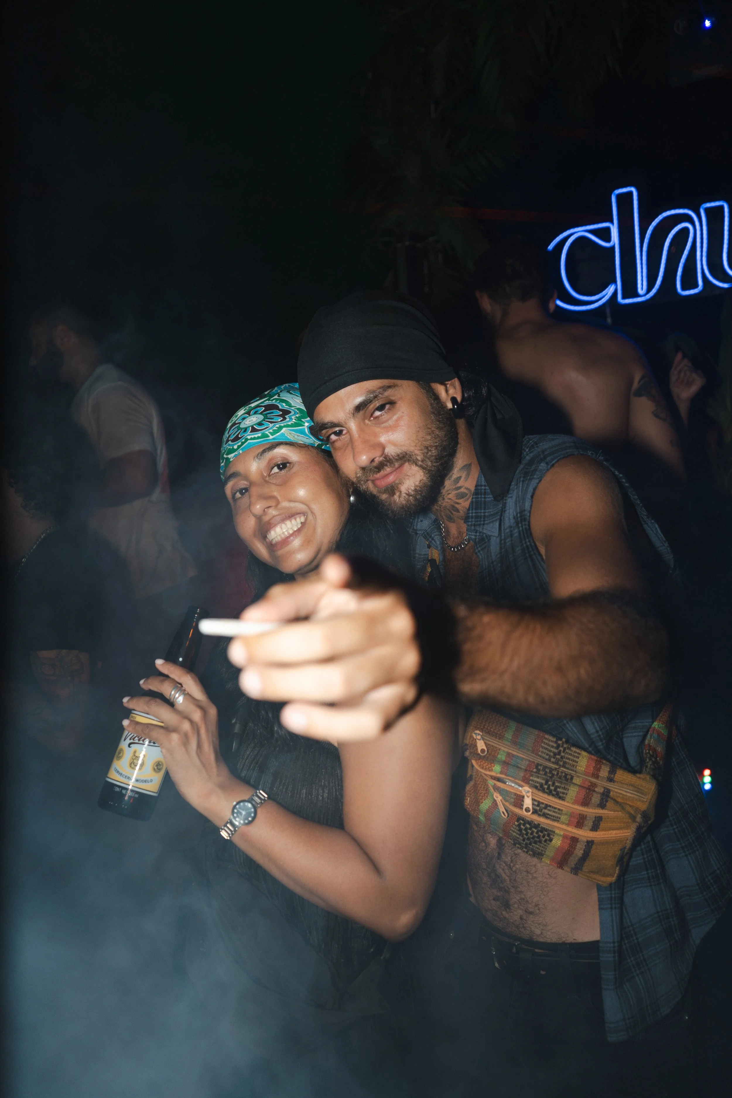 Guests interacting and engaging with the camera at a vibrant party, drinks, styling and neon atmosphere captured for event and nightlife photography