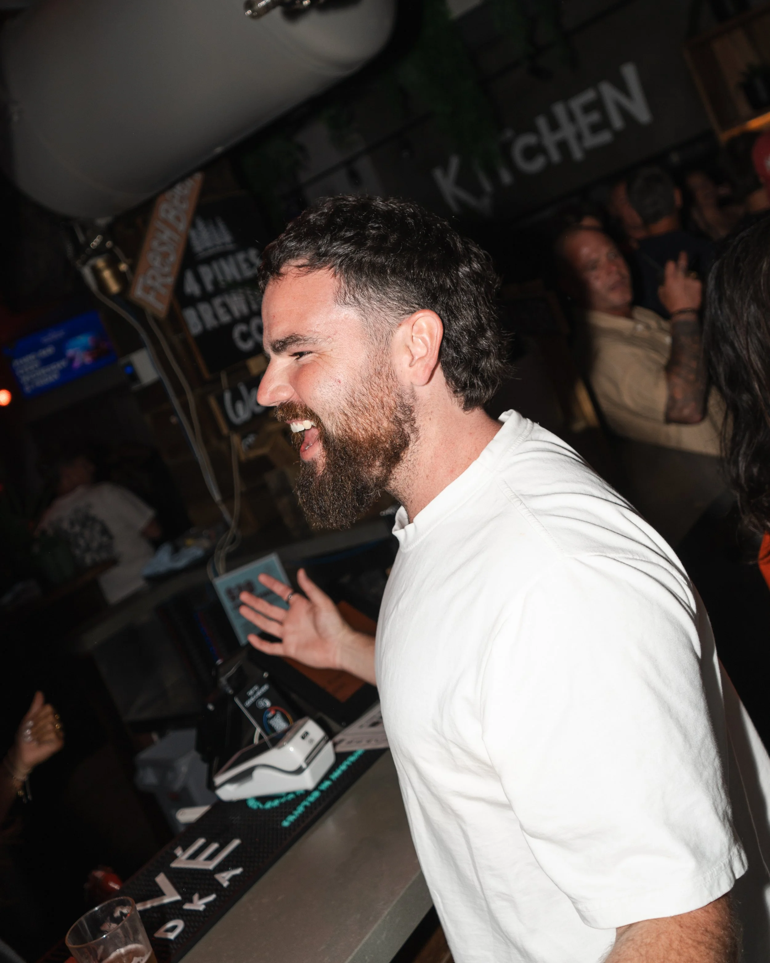Guest enjoying conversation at a Noosa bar with natural candid expression, ideal for hospitality branding and Sunshine Coast event photography