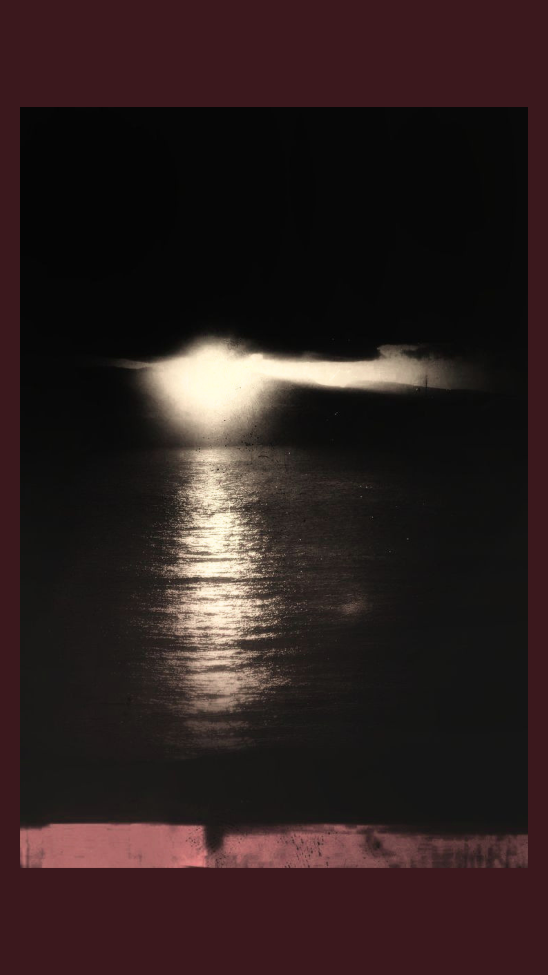 A dark sky with heavy storm clouds and a bright lightning strike illuminating the water below, reflecting the lightning's light.