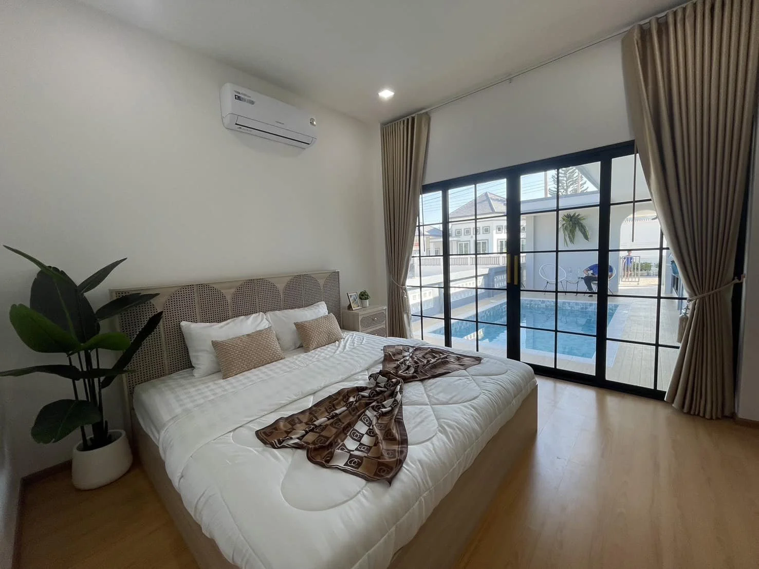 A breathtaking view from the master bedroom through large sliding glass doors directly onto the private turquoise pool.