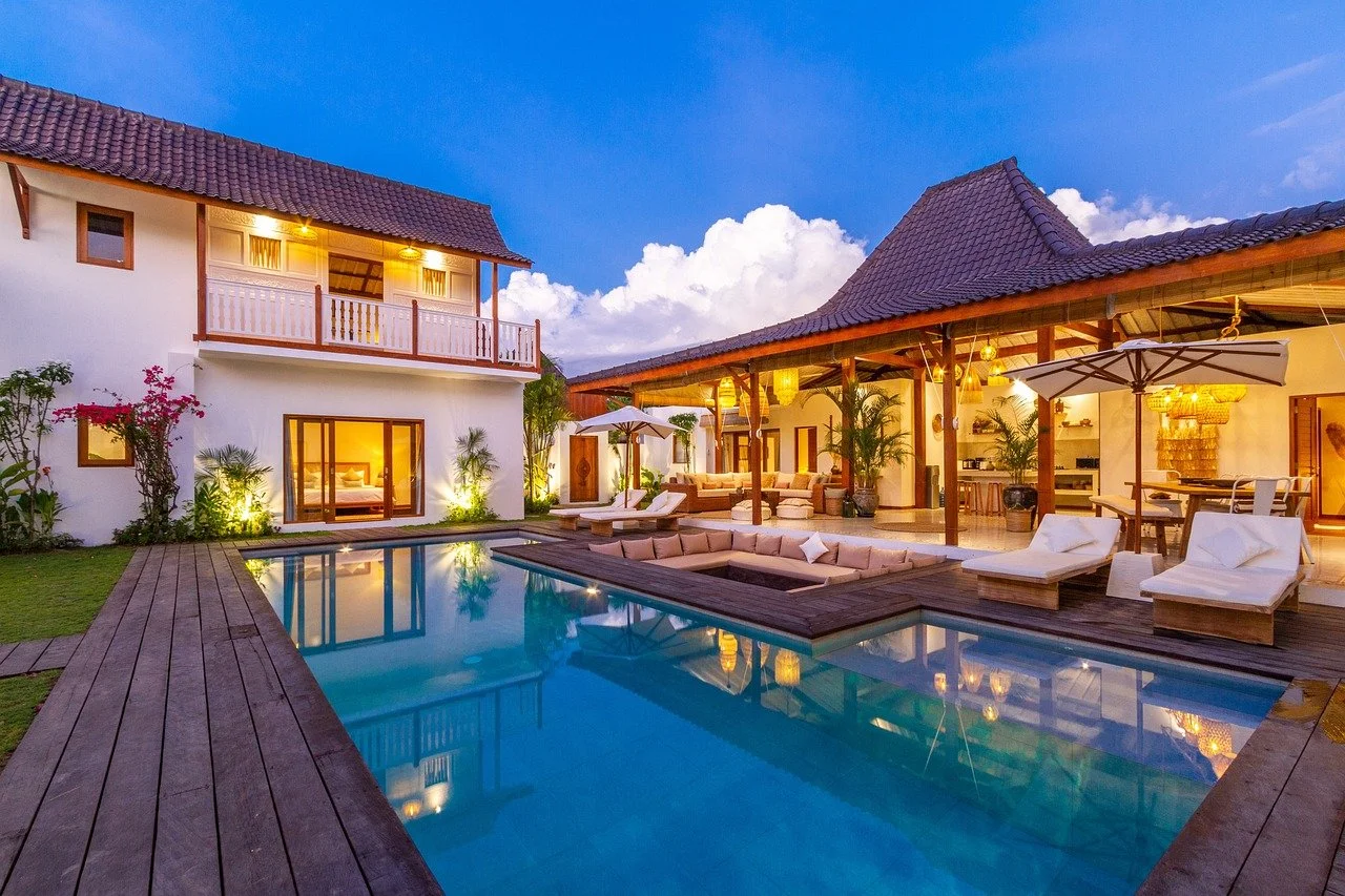 A luxury, hand-picked boutique villa with a private pool and sunken lounge at twilight, showcasing high-value real estate investment potential for capital appreciation in Hua Hin, Thailand.