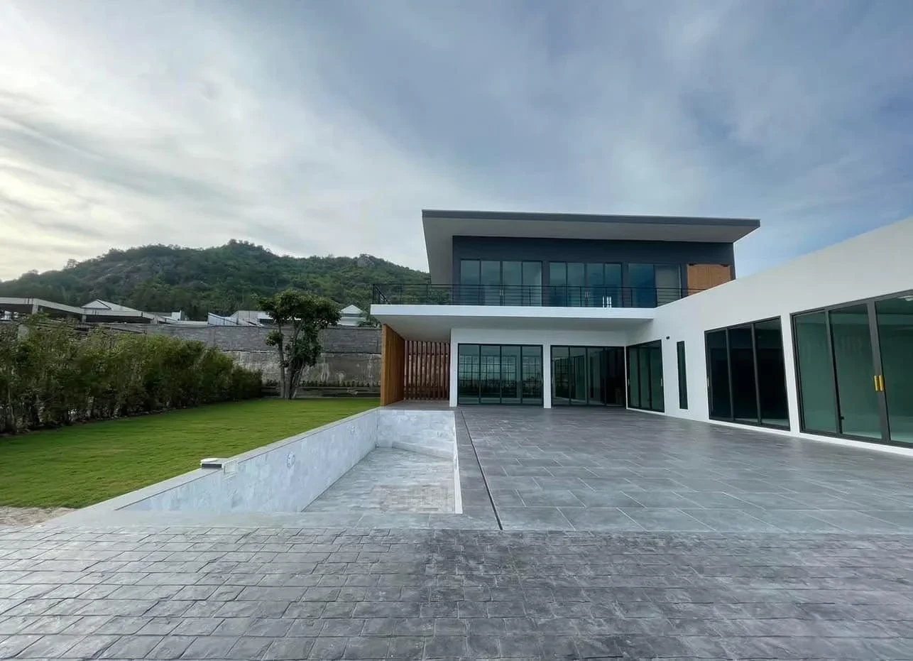 Expansive 250 sqm outdoor living terrace with premium tiling, mountain views, and integrated 12.5m lap pool for family entertainment.