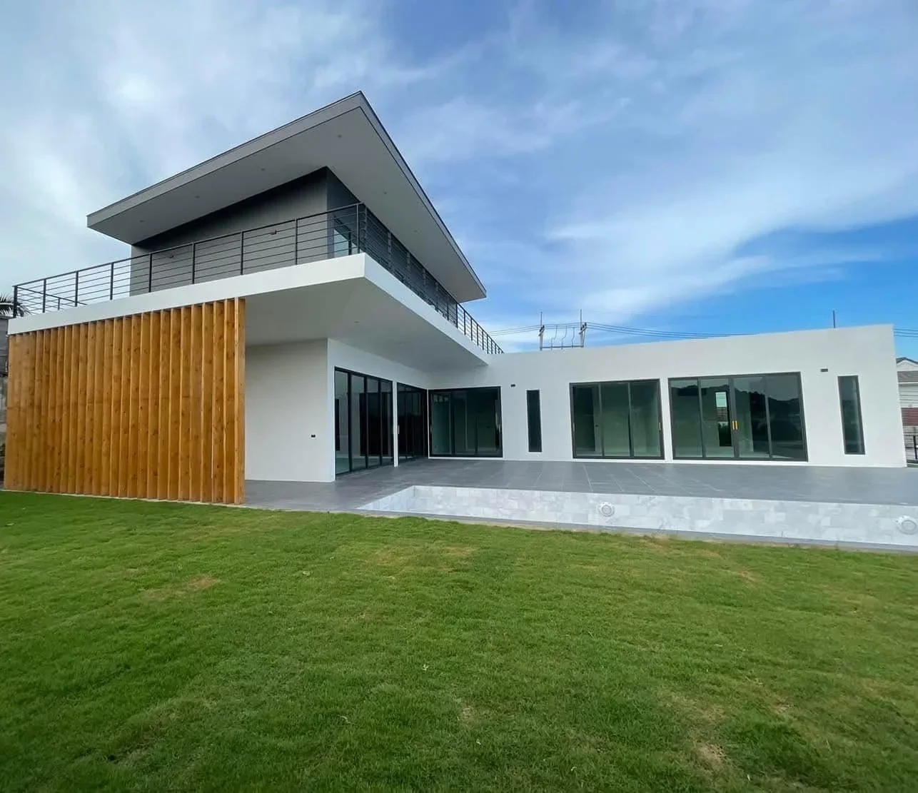 Modern 5-bedroom two-story pool villa exterior featuring clean architectural lines, a large garden, and a private swimming pool in central Hua Hin.