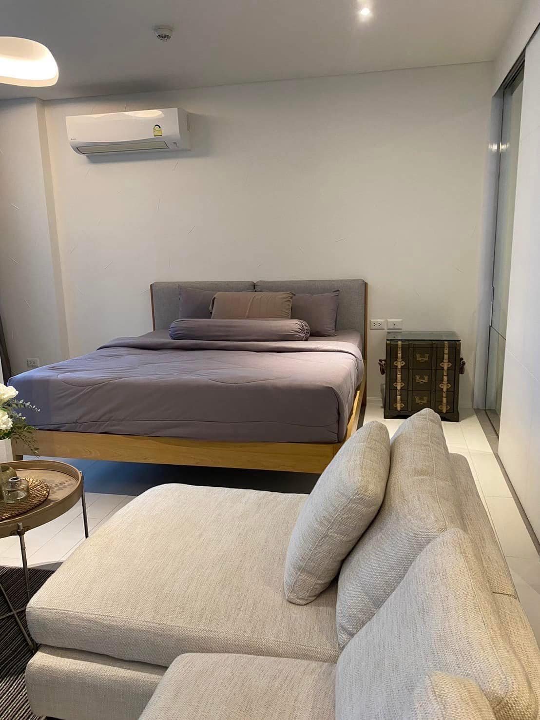 Master Suite Serenity: A refined sleeping quarters featuring a plush king-sized bed adorned with charcoal linens.