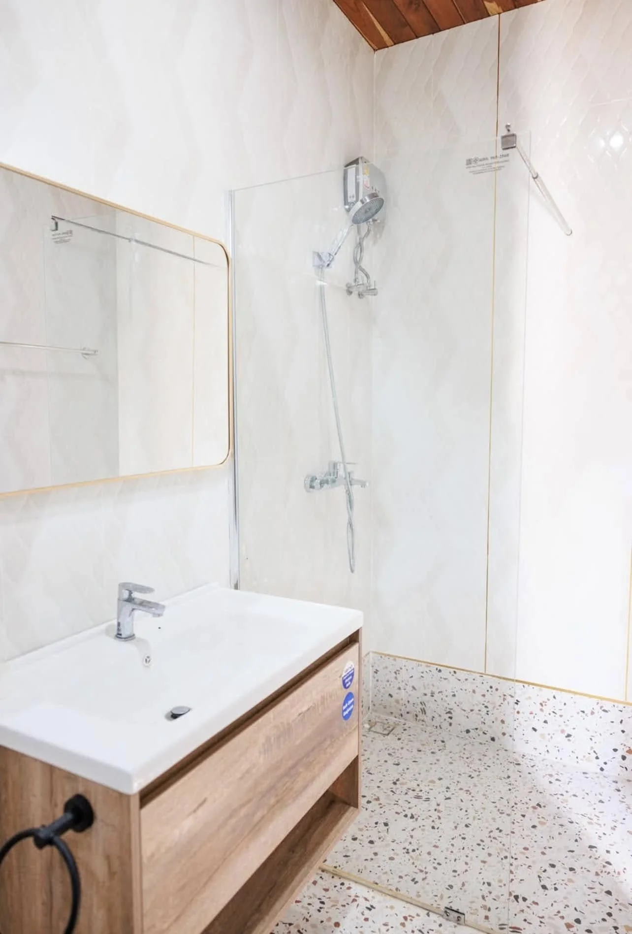 Pristine Master En-Suite: A bright and modern wellness space featuring a floating timber vanity and a glass-enclosed rain shower.