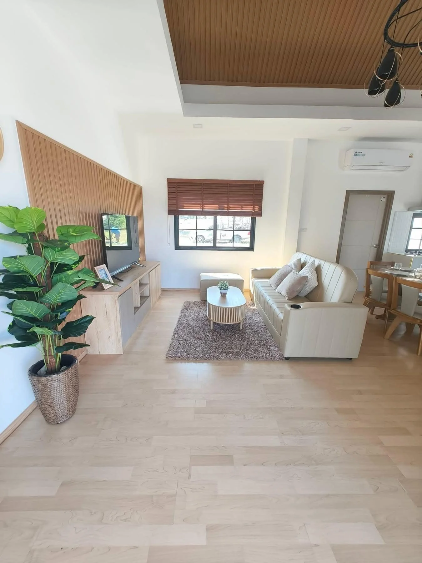 A sophisticated lounge space showcasing a contemporary neutral-toned sofa.