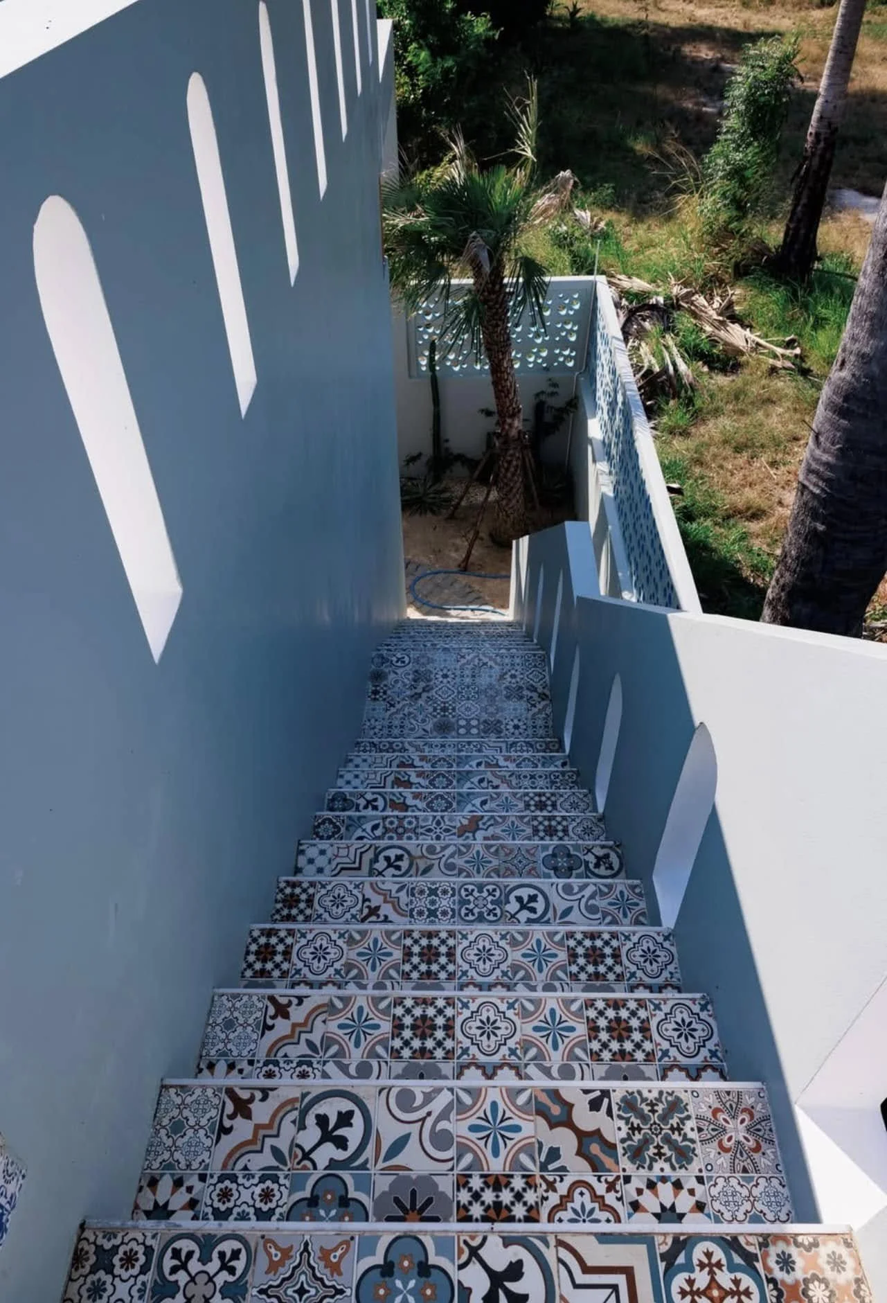 Decorative Tiled Passage: A stunning exterior staircase adorned with intricate, Mediterranean-inspired monochromatic tiles.