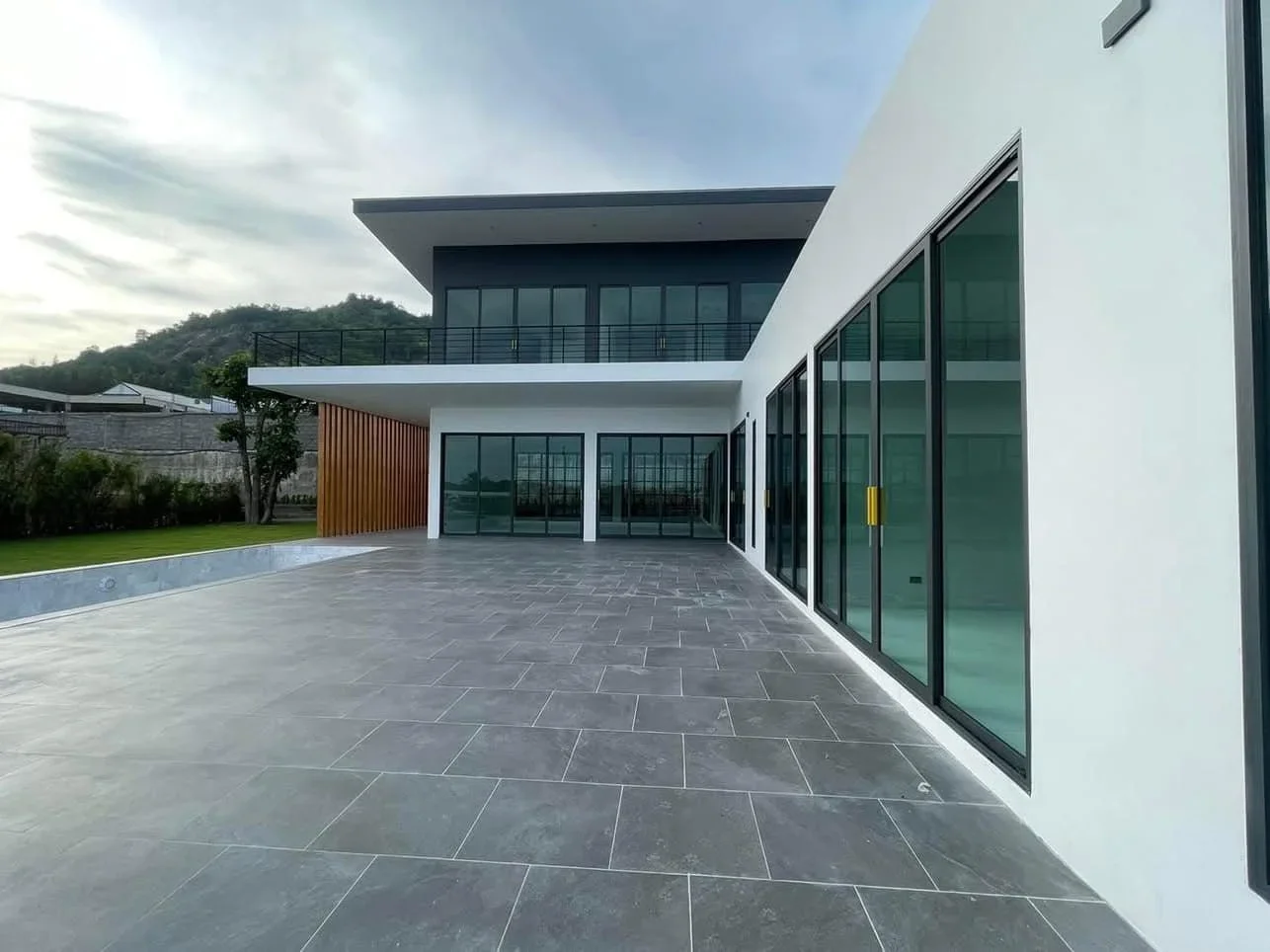 Detailed view of the outdoor terrace and large windows, illustrating the seamless indoor-outdoor living flow of the 5BR residence.