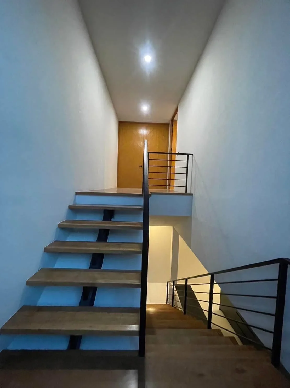 View of the multi-level staircase and landing, showcasing the modern architectural flow and high-quality finishes of the property.