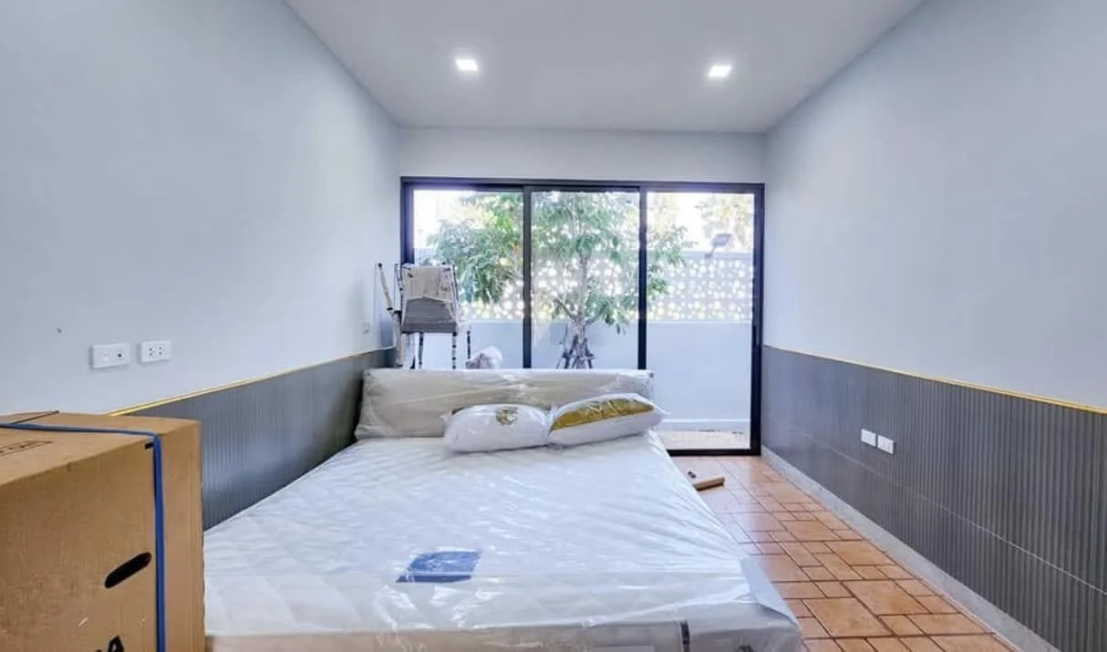 Minimalist Rest Space: A secondary bedroom suite defined by clean lines and soft grey accents.