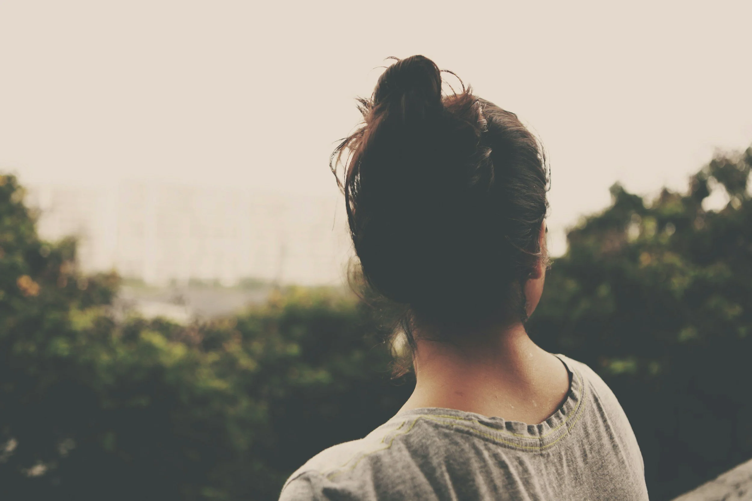 Woman looking out peacefully, representing calm and clarity