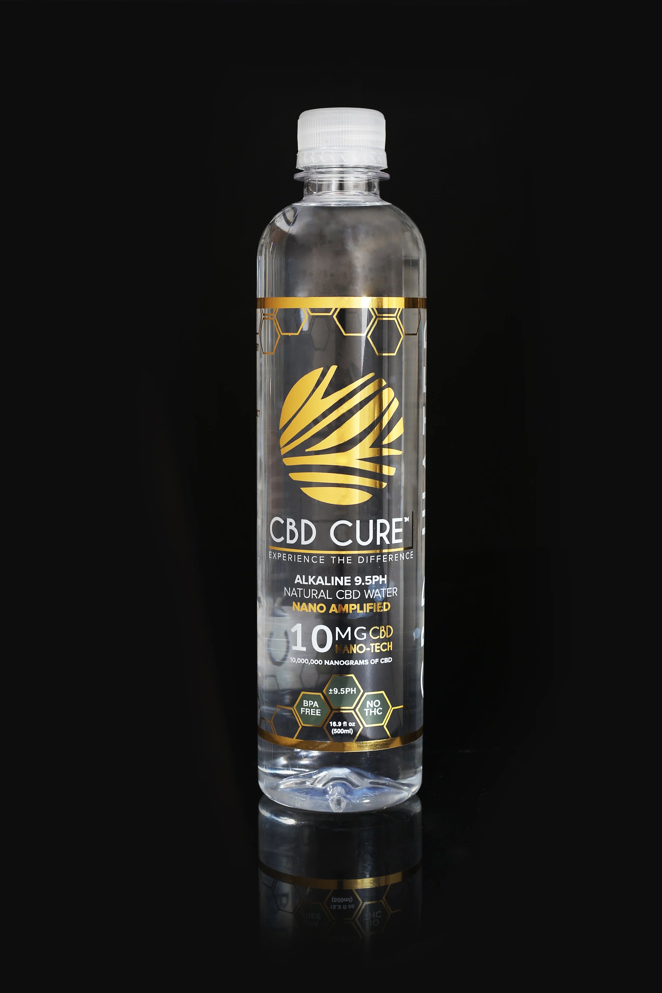 A clear plastic bottle of CBD water with black, gold, and white labeling set against a black background.