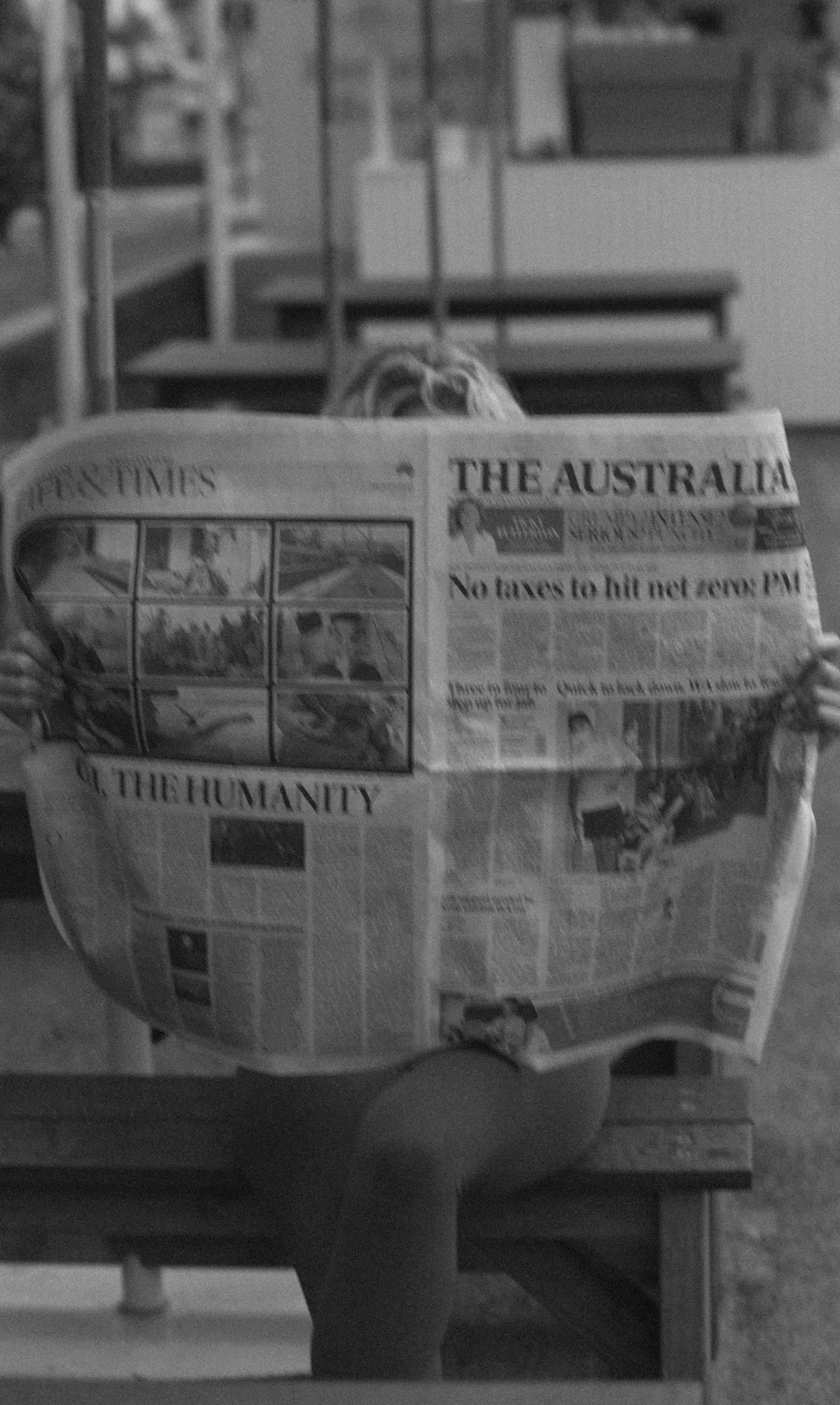 A woman reading the Australian newspaper