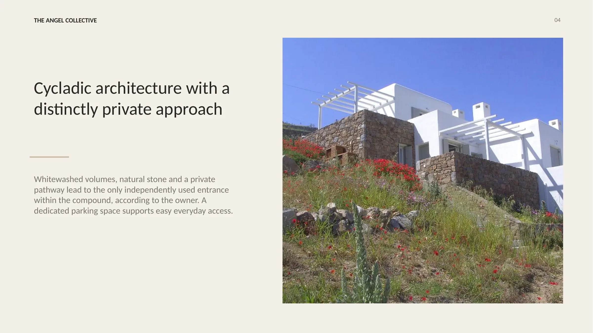 Whitewashed Cycladic villa with natural stone walls, landscaped surroundings and a private entrance pathway.