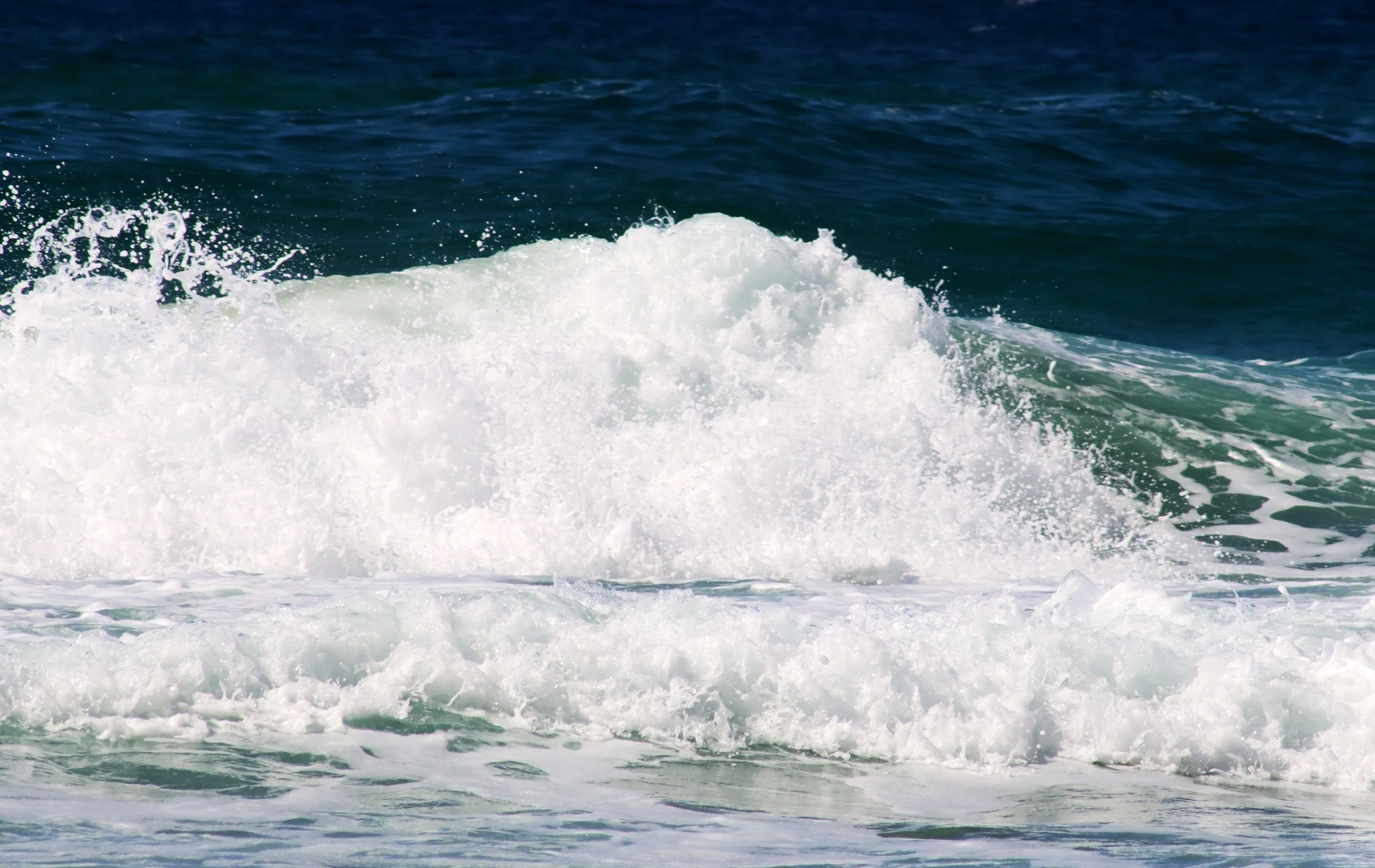 Ocean waves crashing and foaming in the sea.