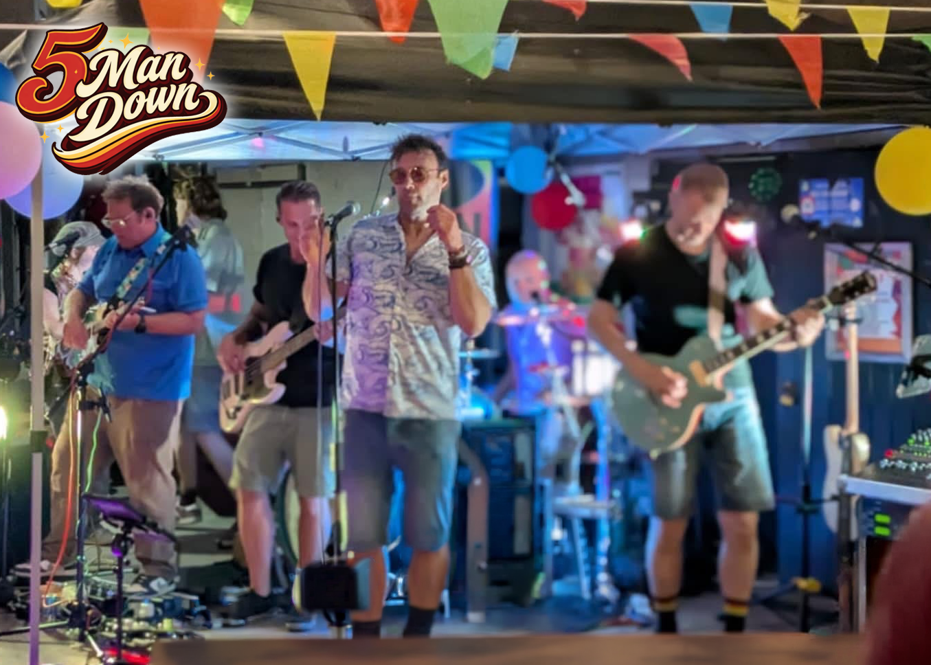 5 Man Down performing live on stage at a North Devon, Party with five musicians playing guitars and a singer in the centre holding a microphone.