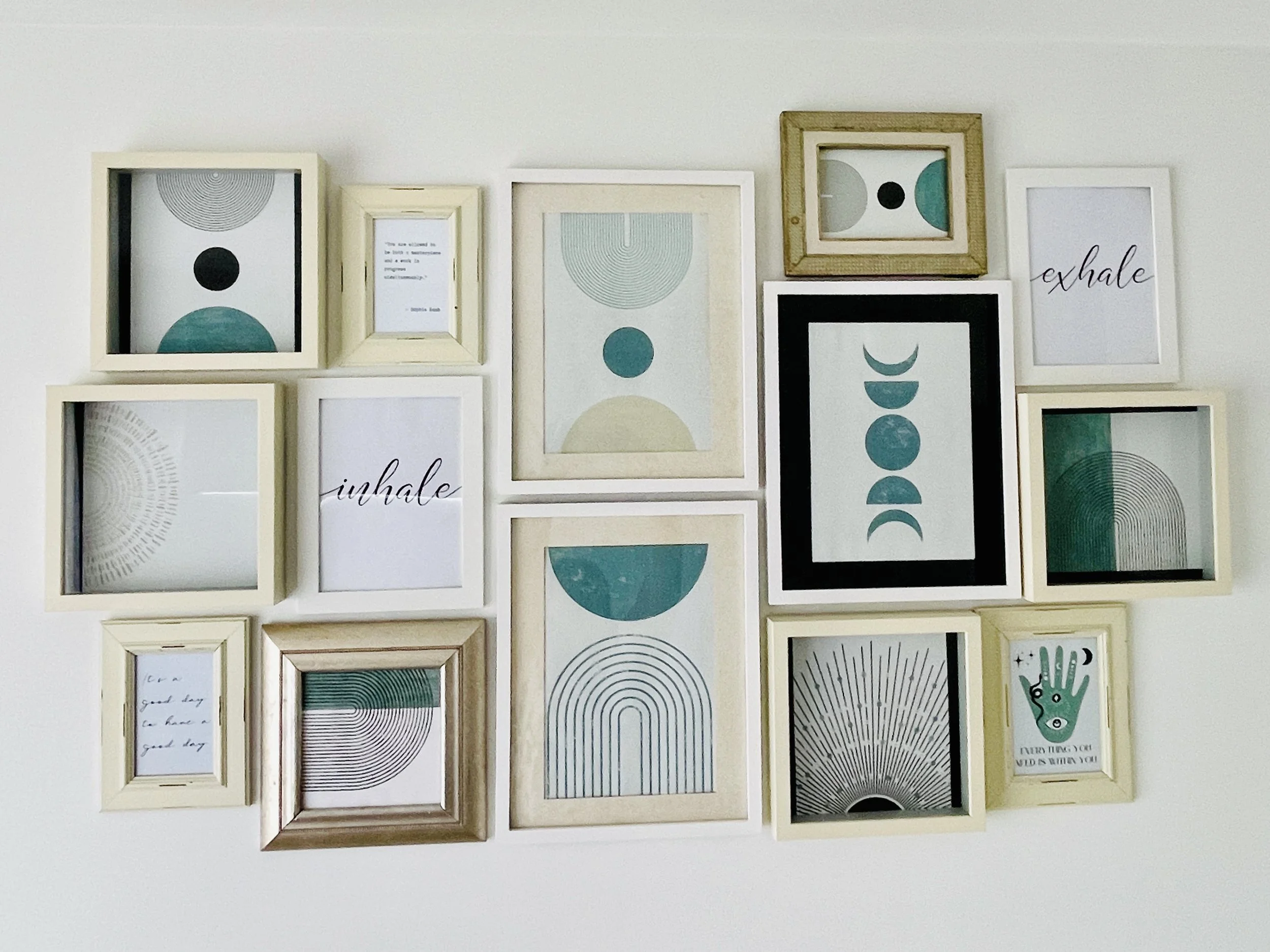 The art in Rebecca's reiki room of minimalistic geometric designs and the words "inhale" and "exhale" on a white wall.