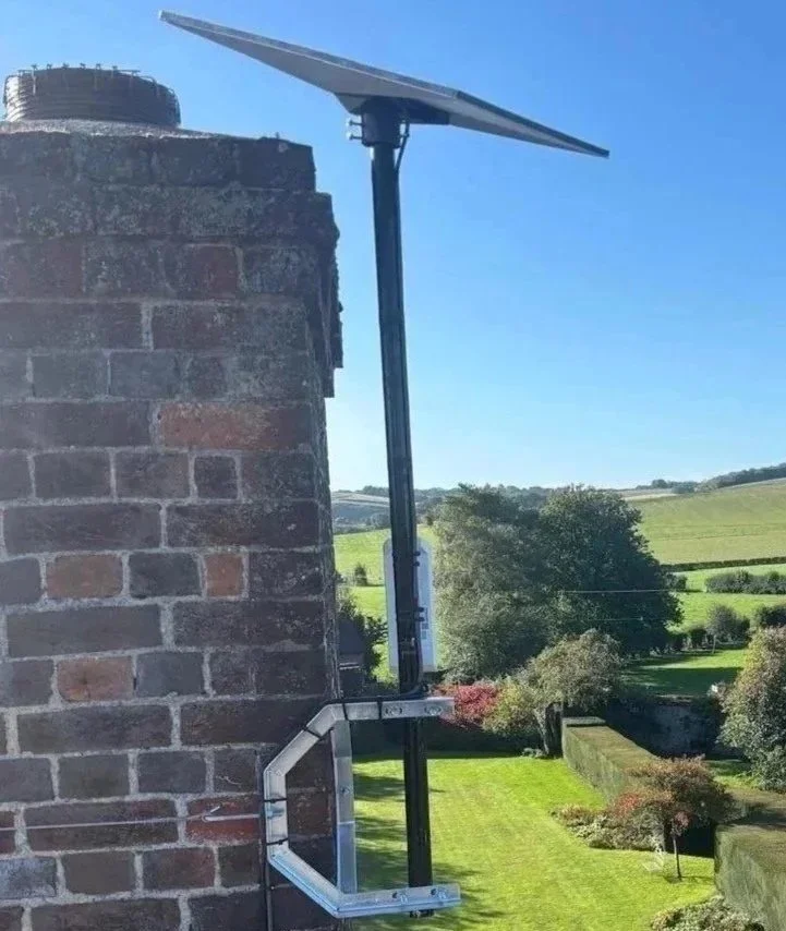 Starlink installation on chimney with blue sky