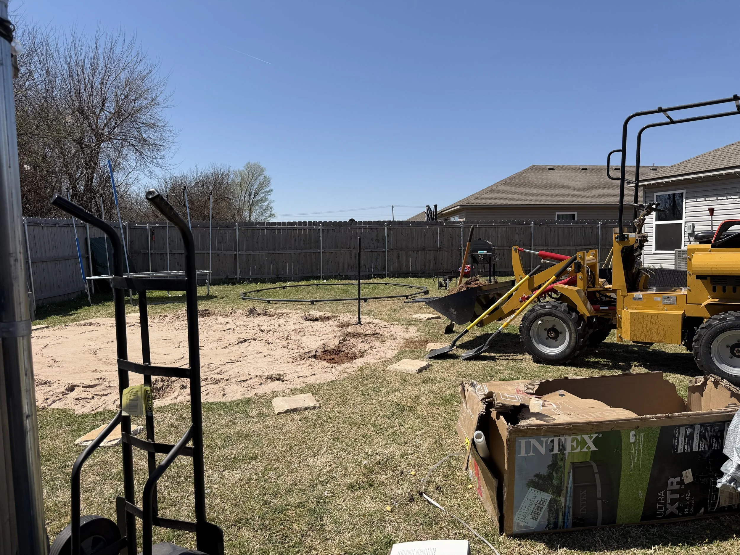 Putting in some sand for a pool install.