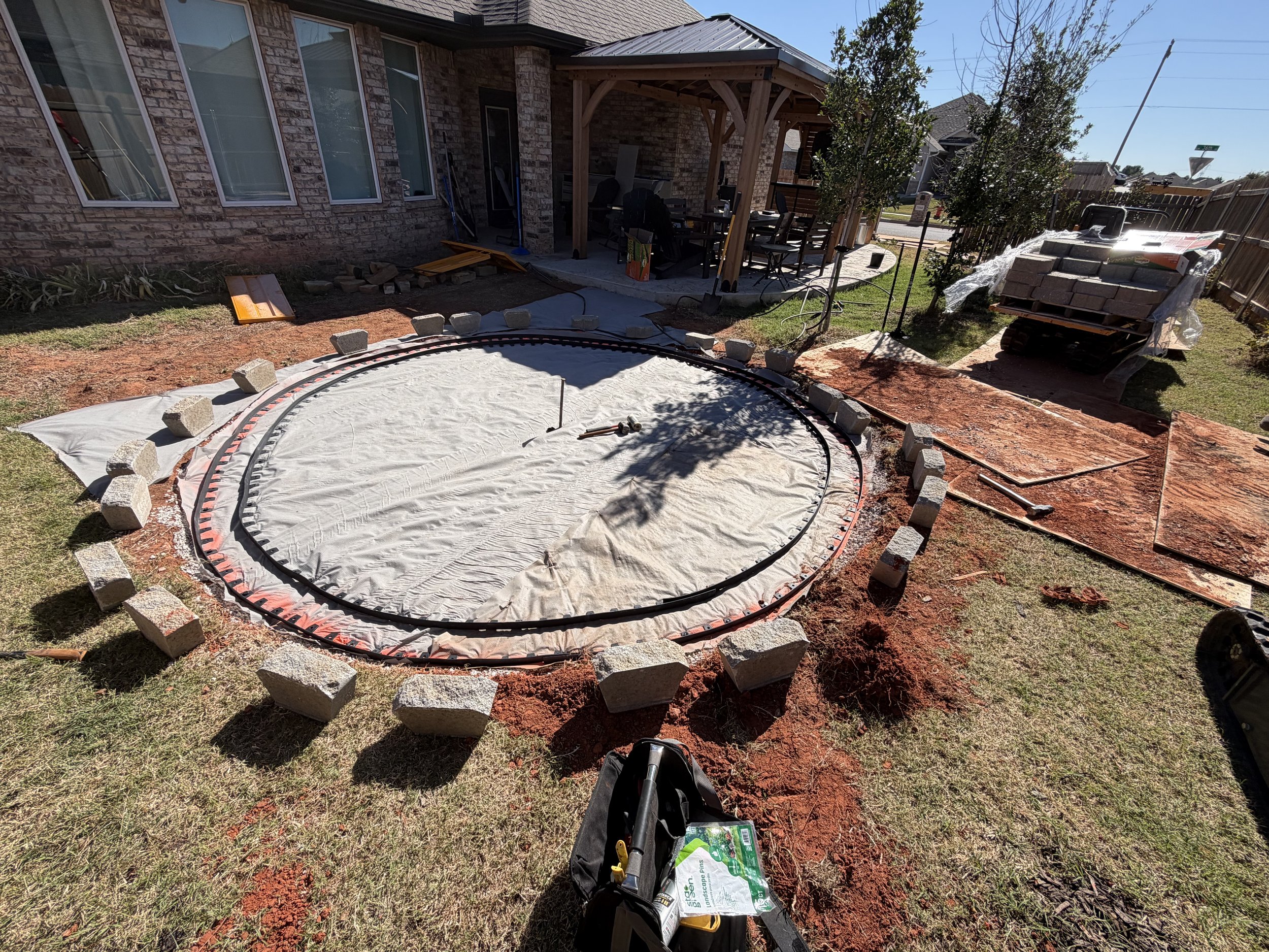 Weed barrier and paver edging installed.