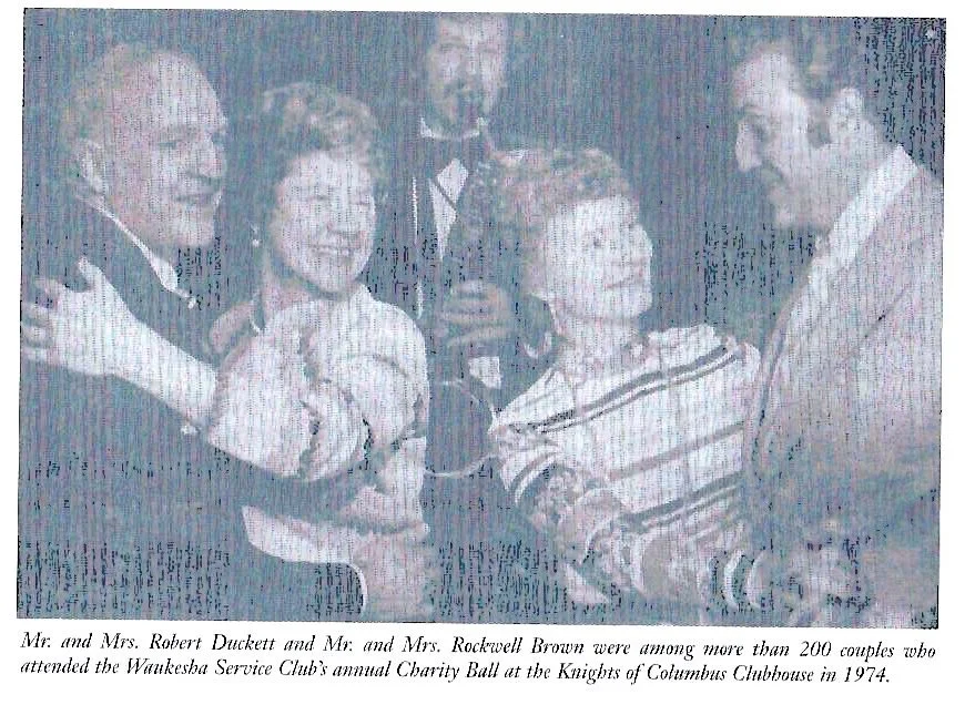 A black and white newspaper photo of two couples dancing at the Waukesha Service Club annual ball.