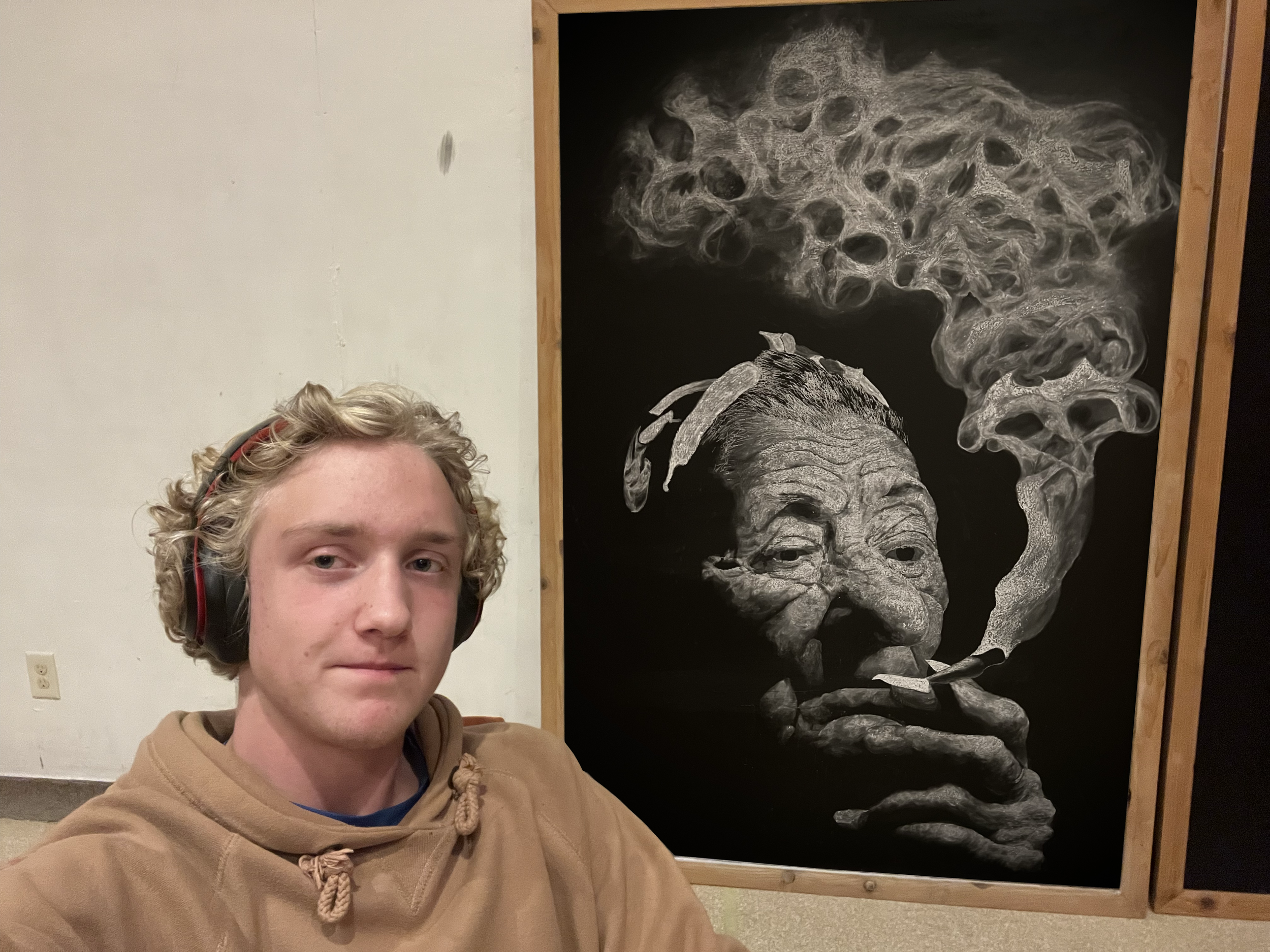 old womans face with smoking or vapor clouds which resemble skulls , in an art gallery, in an art studio. wildflower wild flower halloween chalkboard  chalk mural.