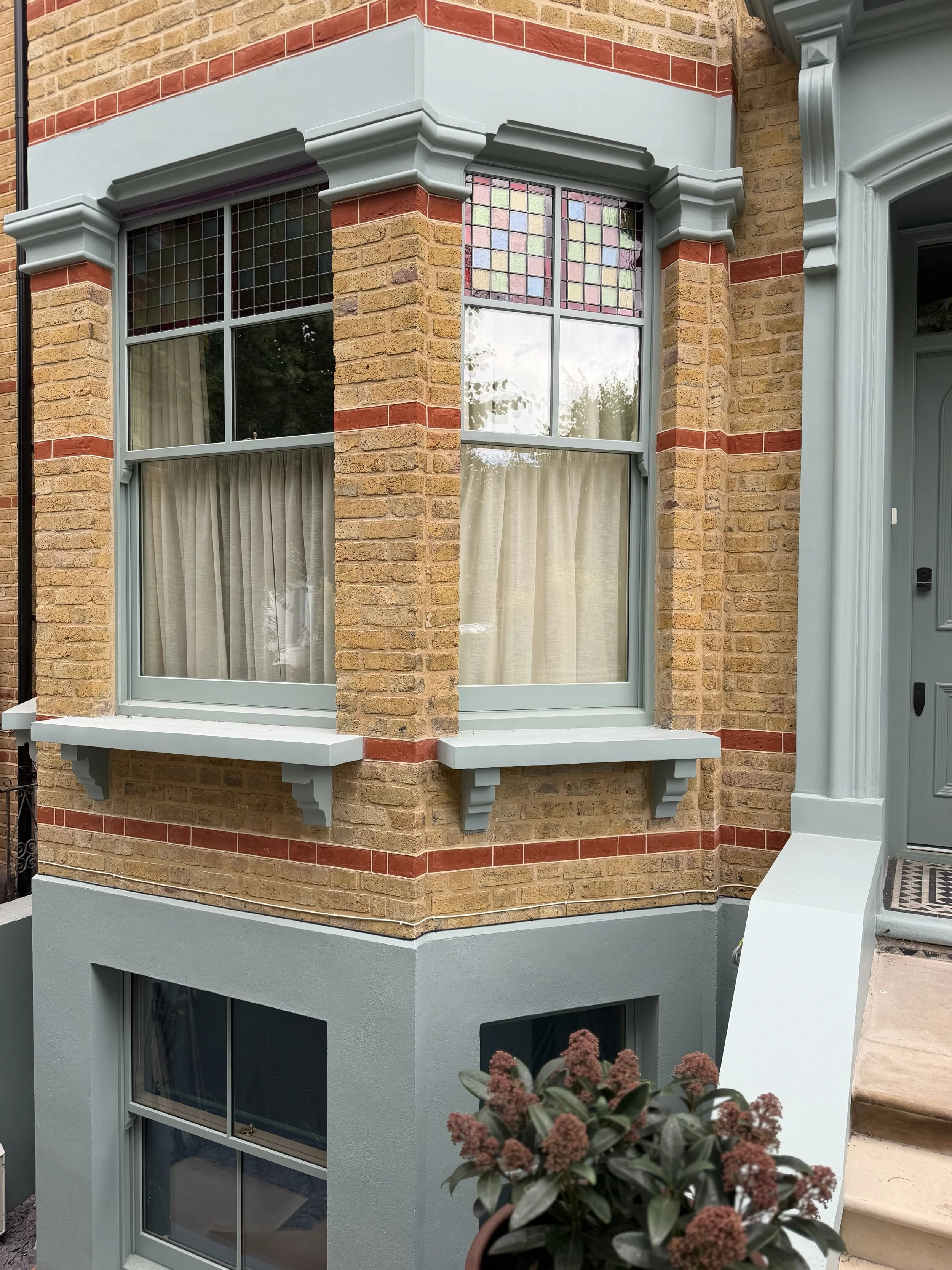 Stunning sash windows with distinctive coloured glass, carefully crafted to echo the original design features found throughout the properties on this welcoming, tree-lined street.
