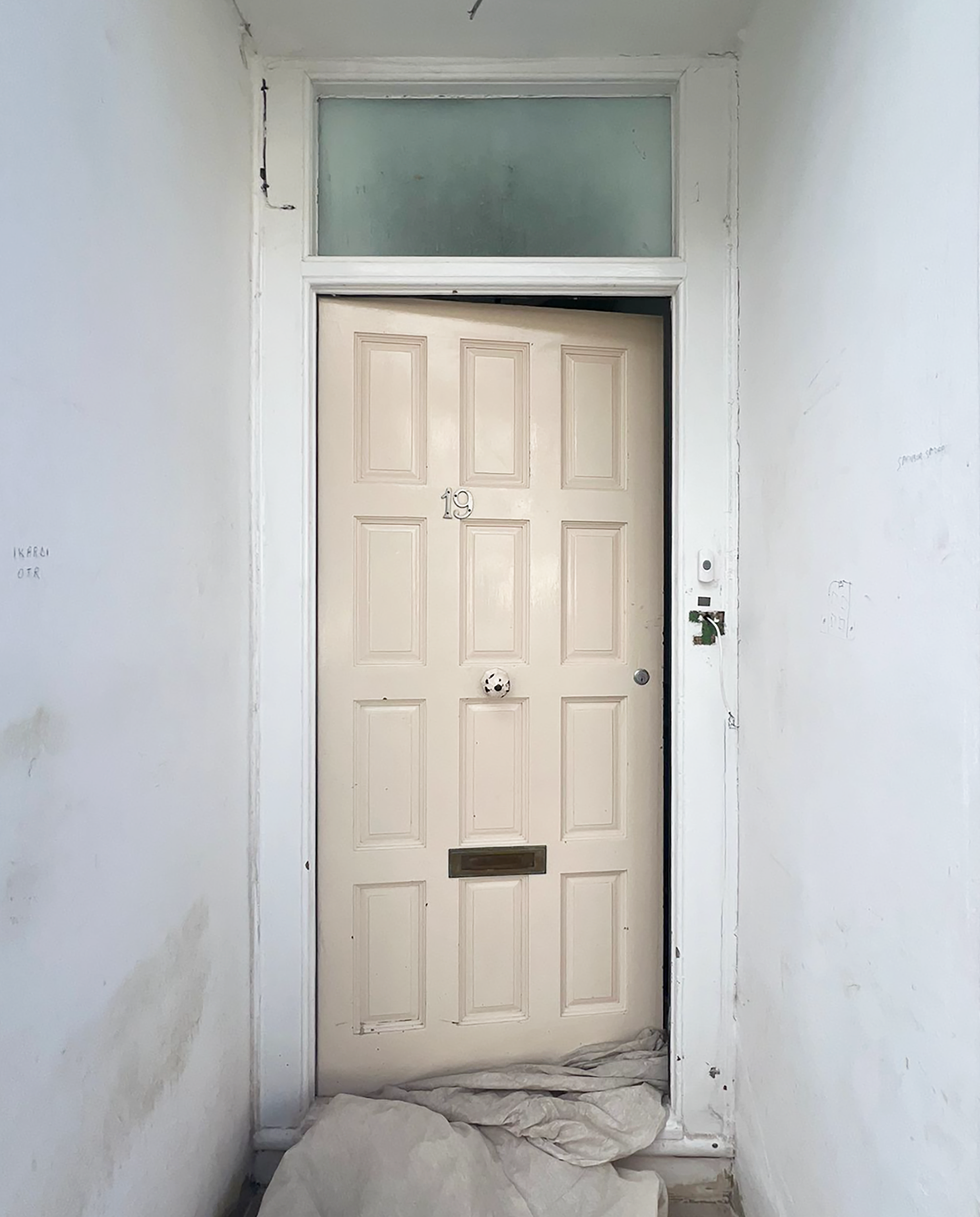 A white front door befroe picture, being replaced.