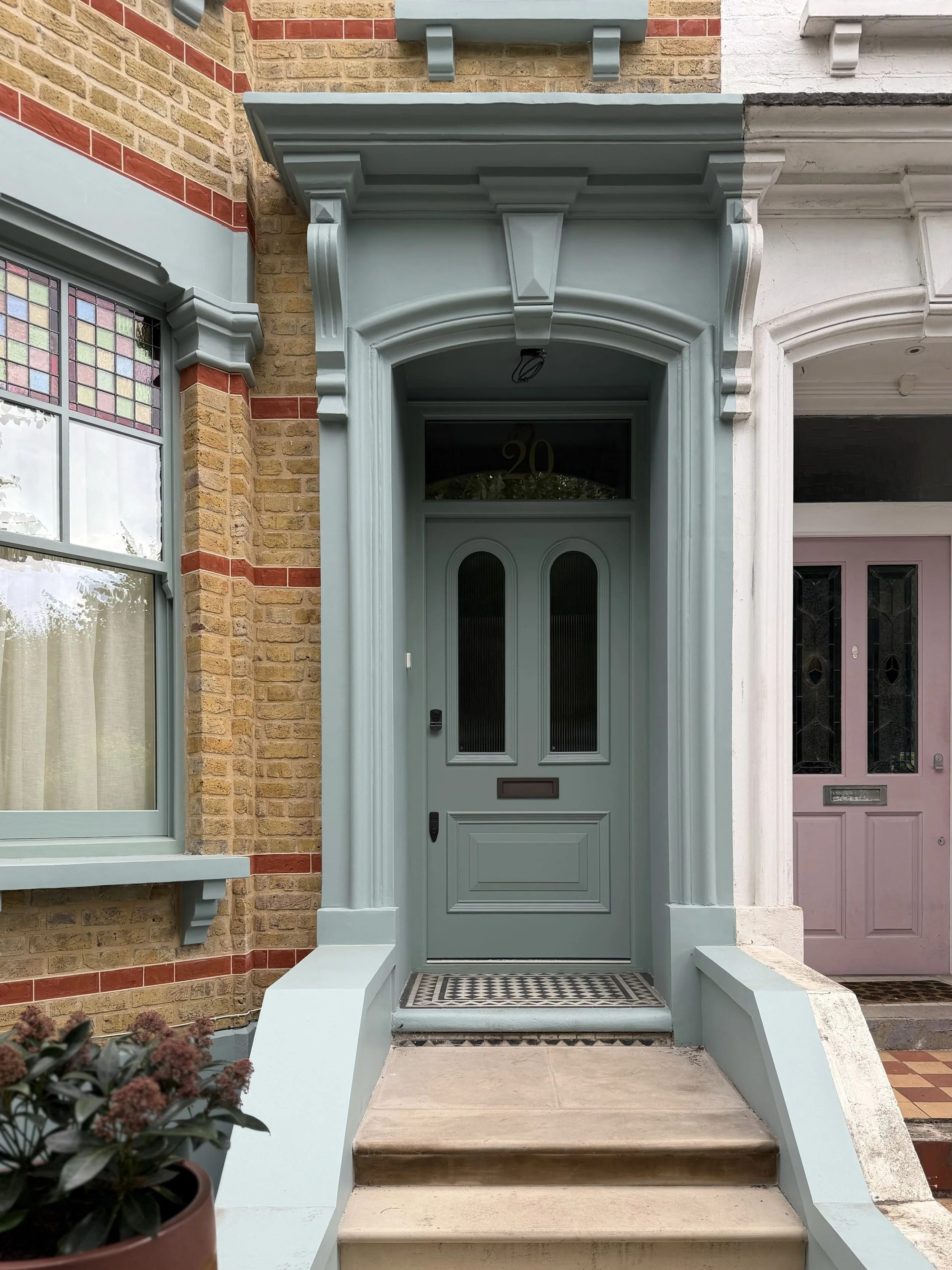 A colour-drenched entranceway, where perfectly matched joinery creates a grand and quietly austere presence, adding an unmistakable sense of kerb appeal.