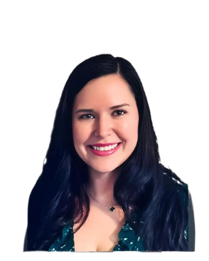 A woman with long dark hair smiling, wearing a green patterned blouse and a small necklace, against a plain white background.