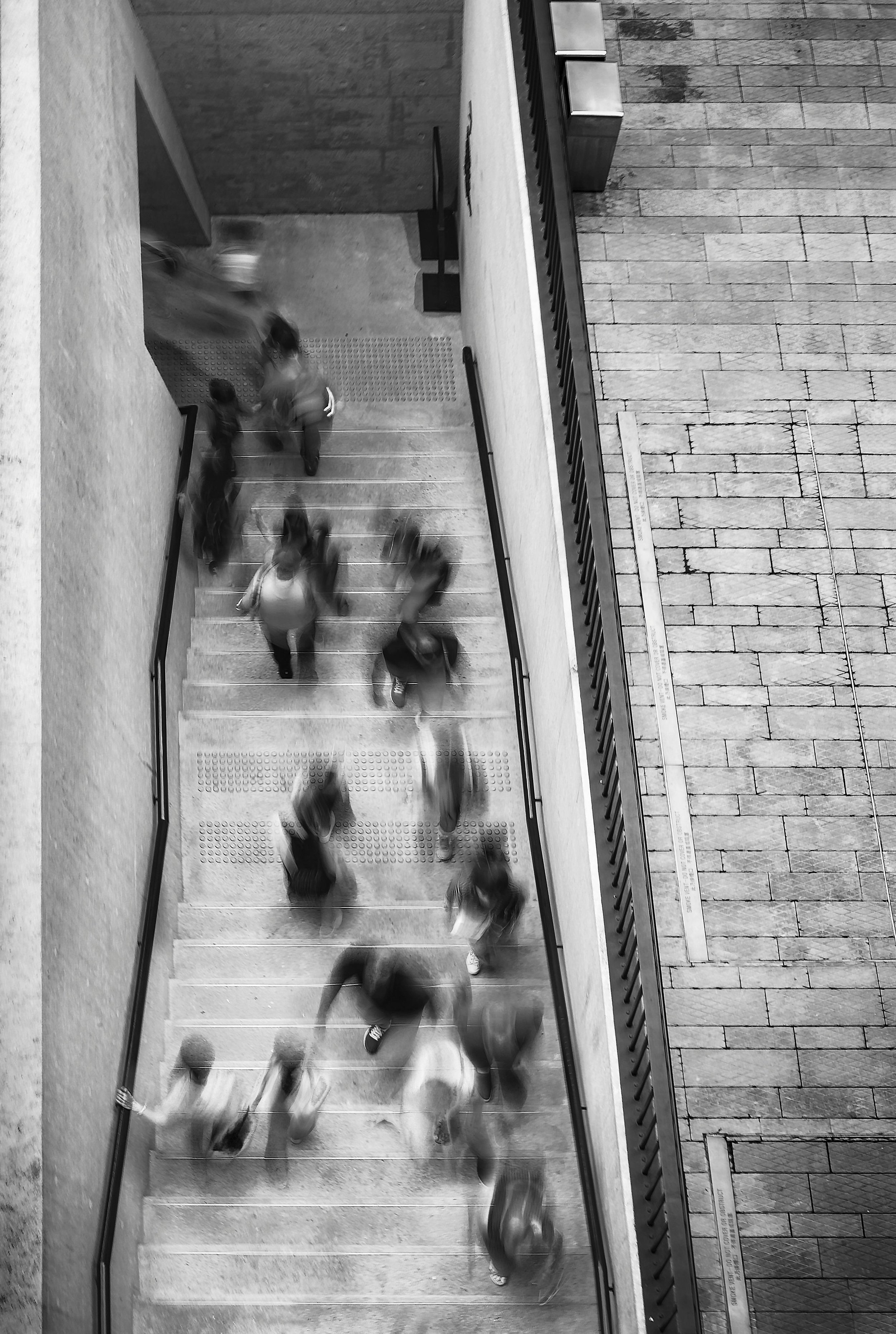 People in motion moving up and down a staircase