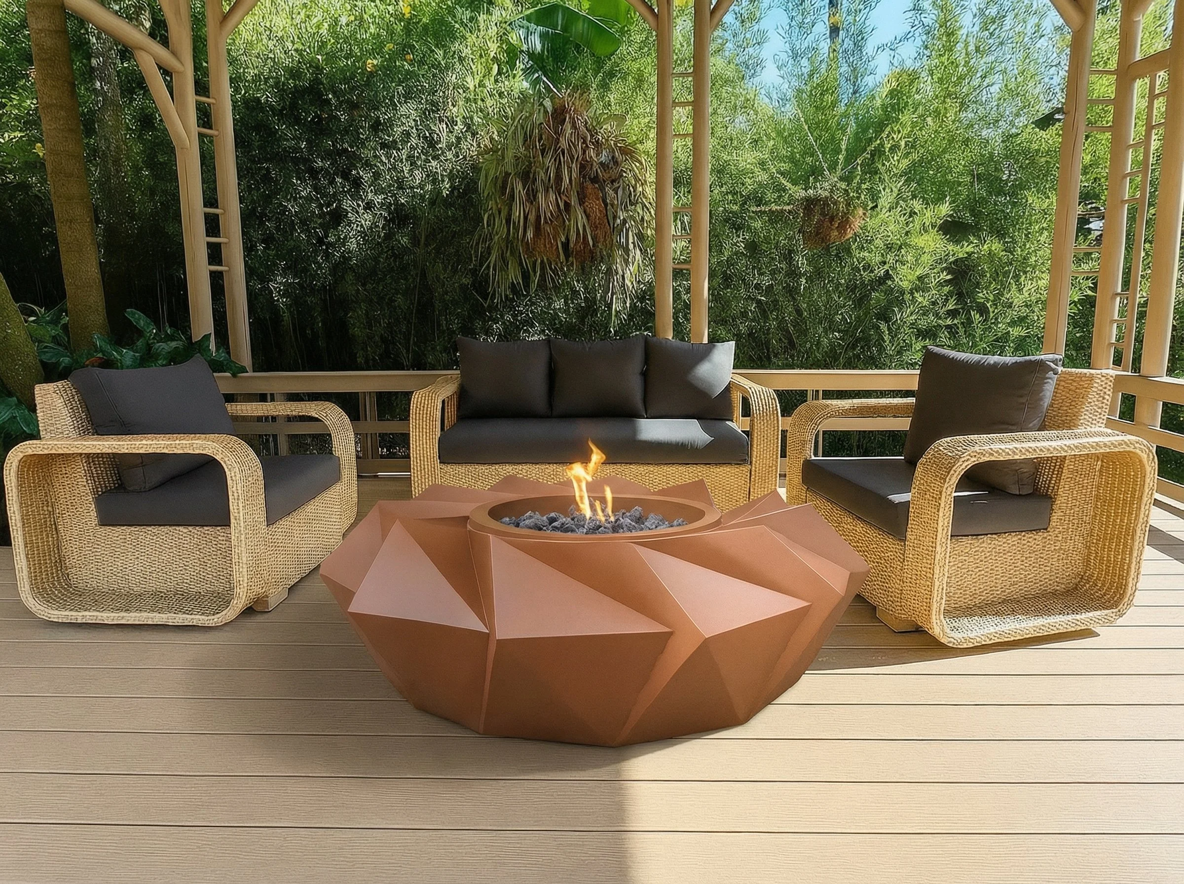 Outdoor seating area with wicker chairs, a black cushioned sofa, and a geometric fire pit table, surrounded by green foliage and trees.