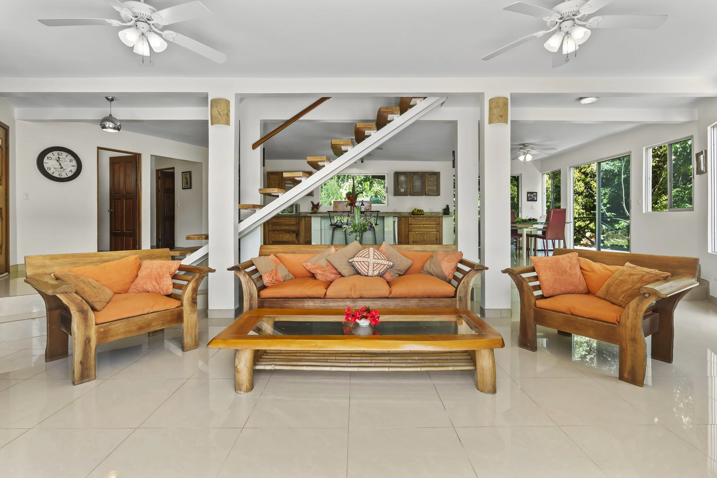 Open concept sunken living room with valley views at Casa Arbol de Vida in Platanillo de Baru, Costa Rica. The wood furniture you see here is artisan created using cedar wood. This wood furniture is included with the home.