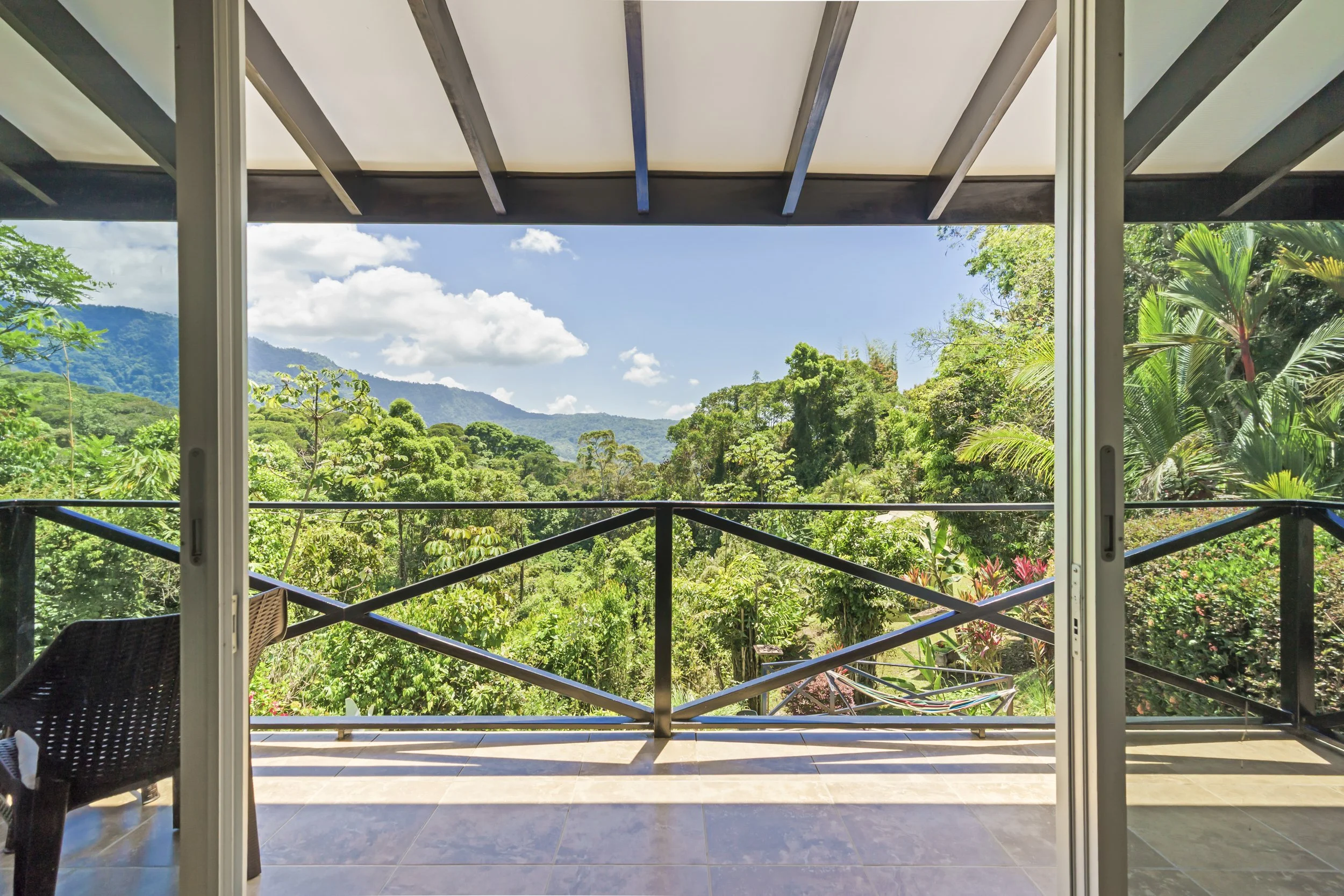 Secondary primary suite balcony -  expansive valley views and natural tropical surroundings. Truly amazing to start your morning here with the sun rising over the mountains.
