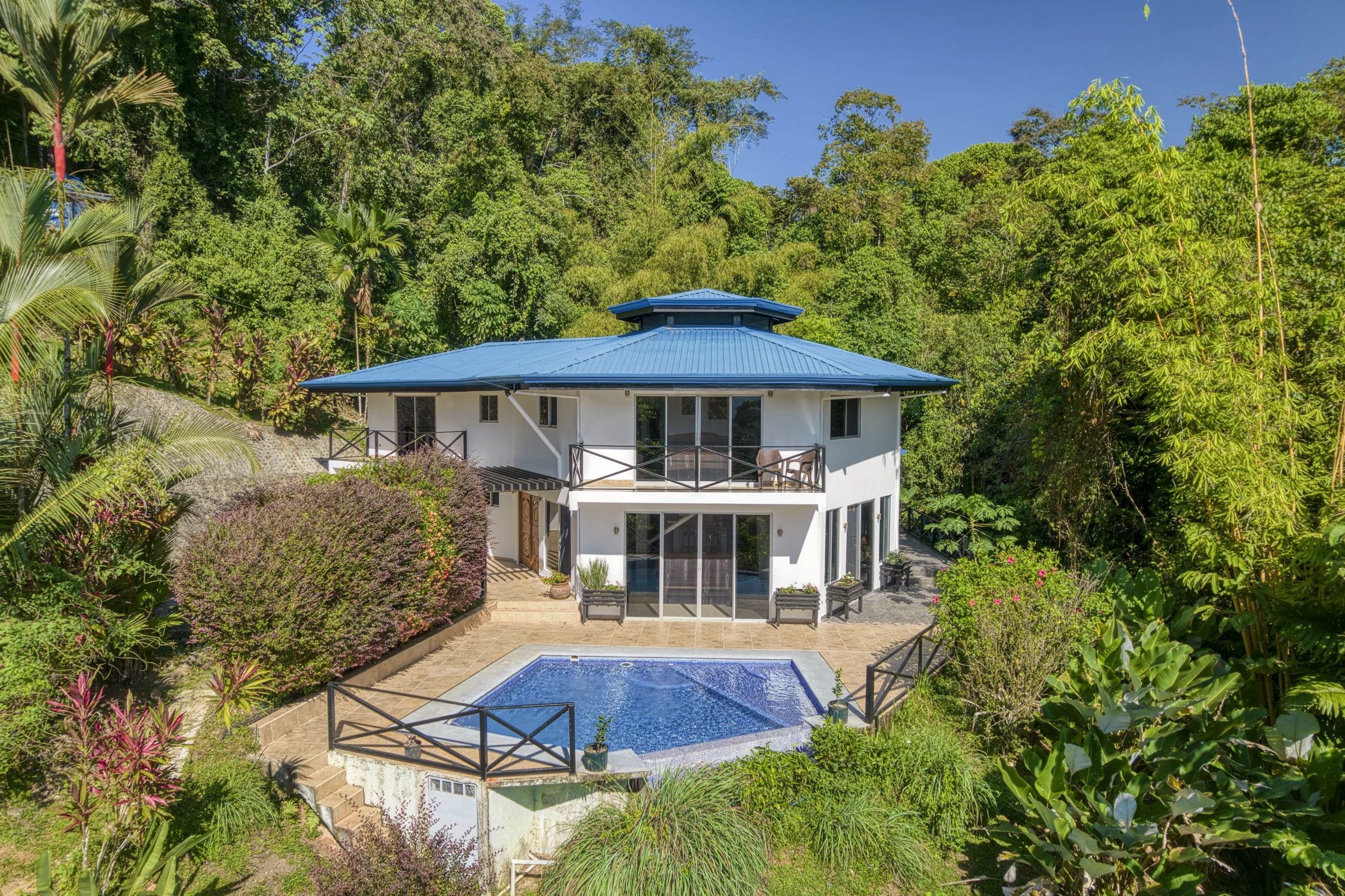 Exterior / side view of Casa Arbol de Vida surrounded by lush rainforest in Platanillo de Baru, Costa Rica.
