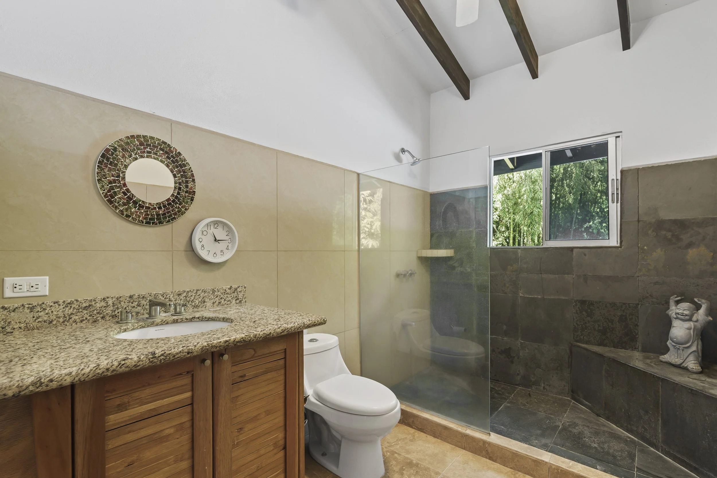 Boasting a huge shower, the upstairs guest bathroom provides comfort and functionality for the estate.