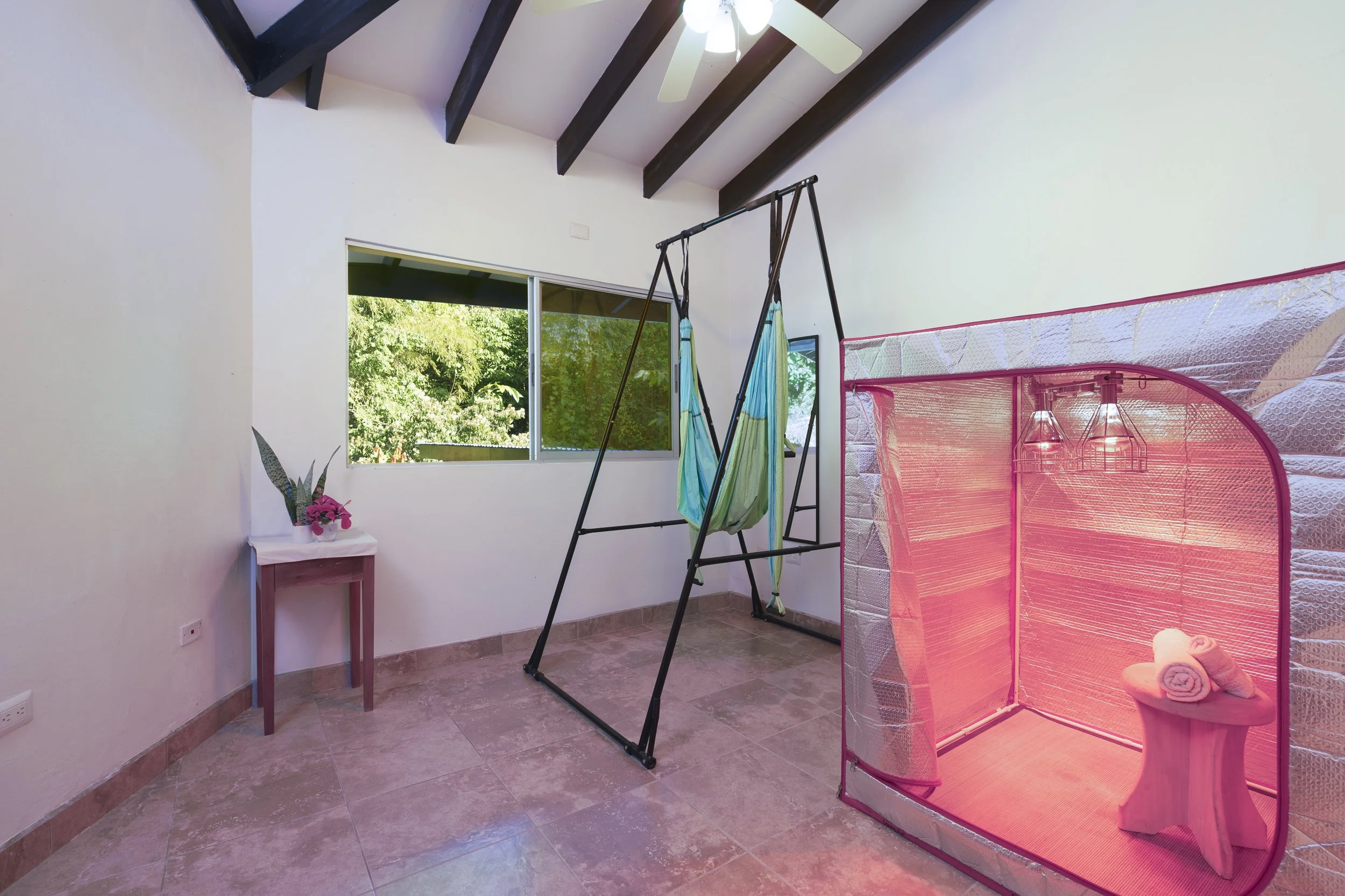 View of the fourth bedroom. Ideal for a sauna, yoga, additional guest room, office or studio, the space looks toward the back yard. The room features air flow that exits the cupola.