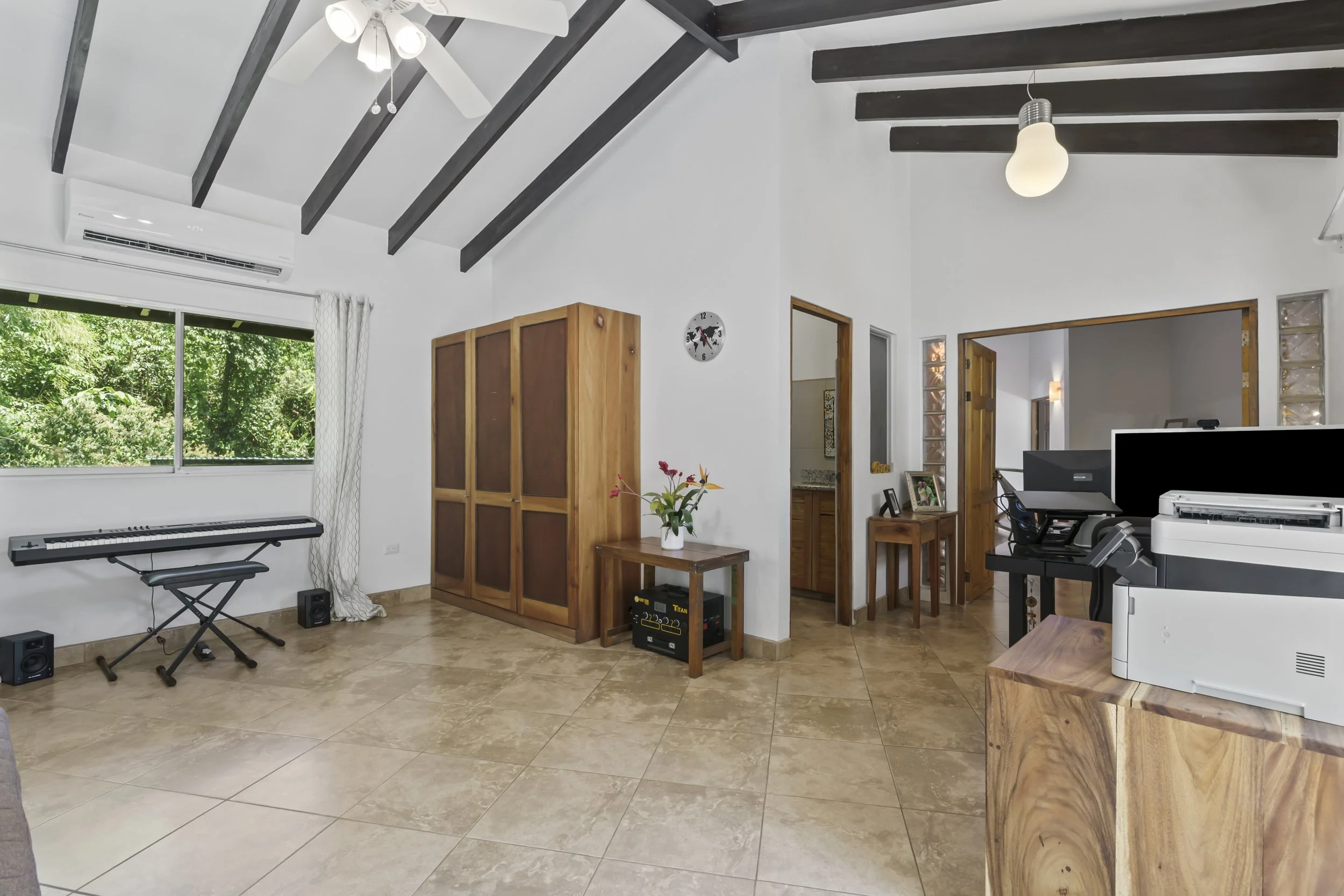 Primary suite featuring air conditioning and tropical views. The double doorway is flanked by glass blocks.