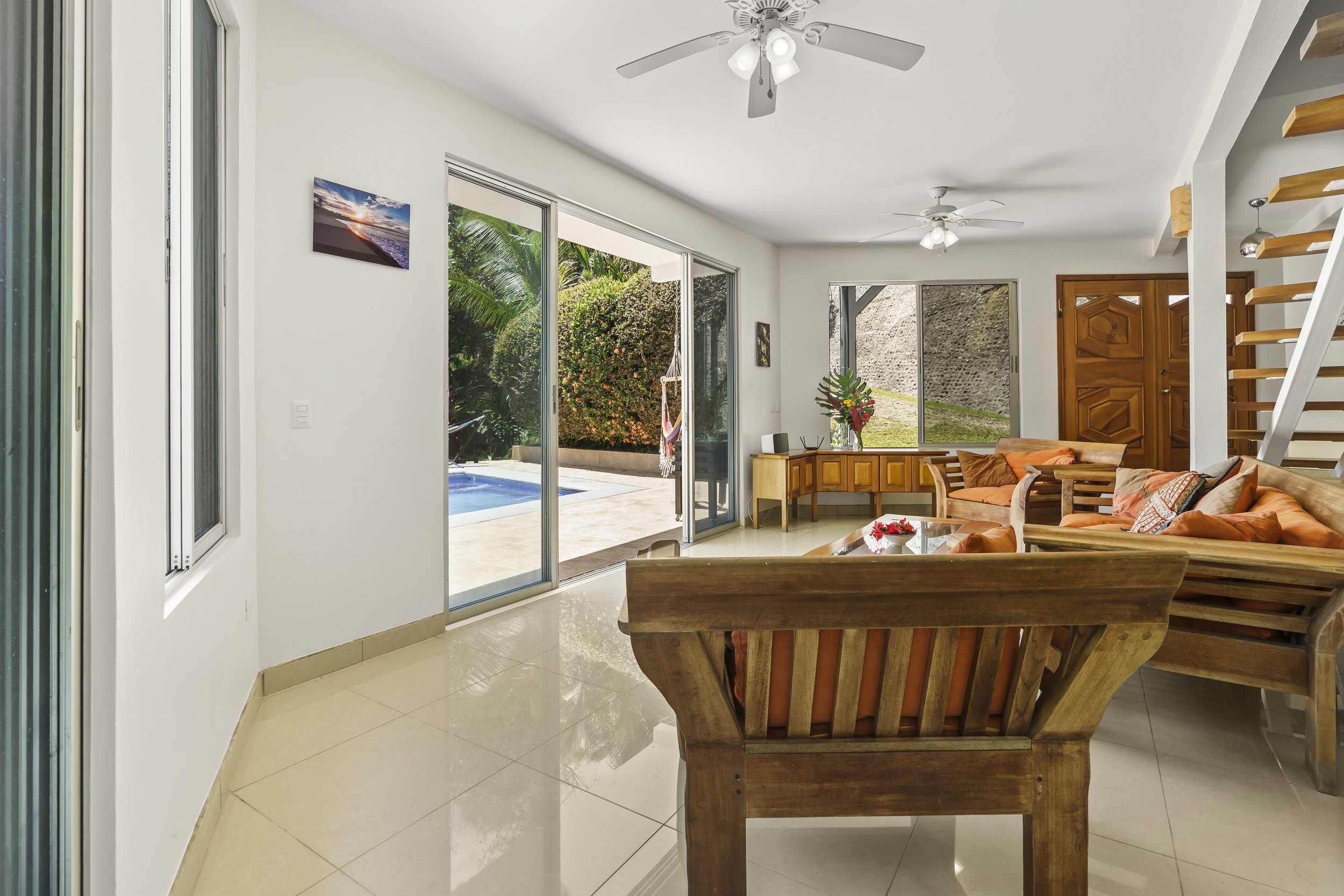 Indoor-outdoor living created by large sliding doors opening toward the pool terrace.