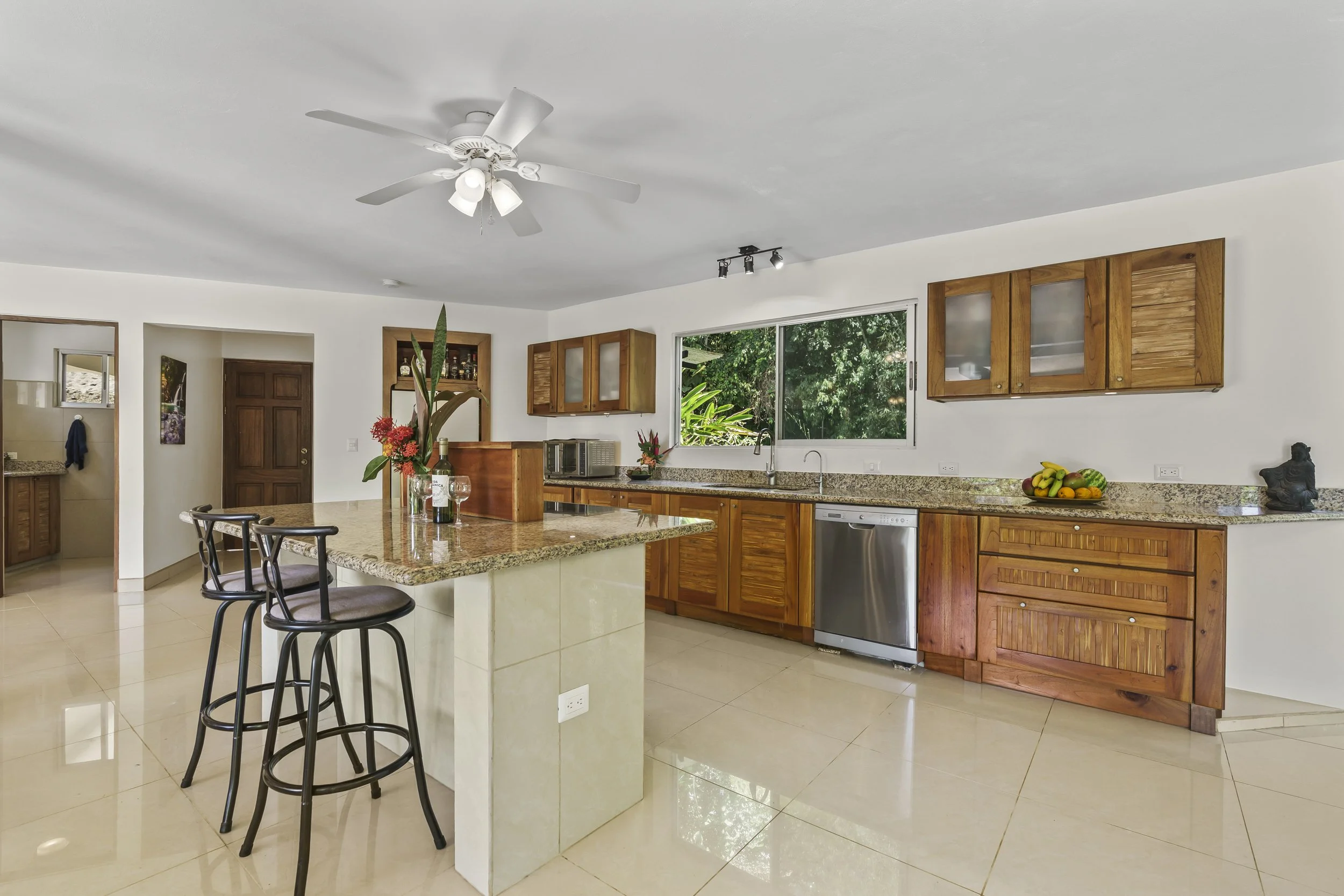 Modern kitchen design with ample natural light and open layout. Barstools are included. The cedar cabinetry features in- and below- cabinet lighting with frosted glass.