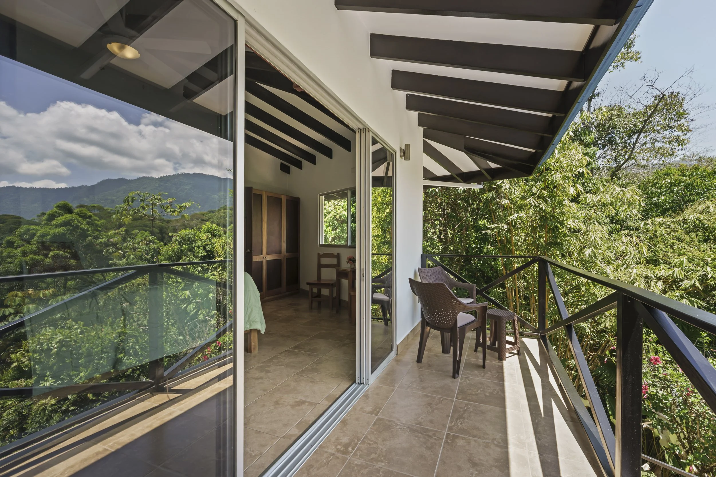 Balcony connected to the second primary suite offering peaceful rainforest views.