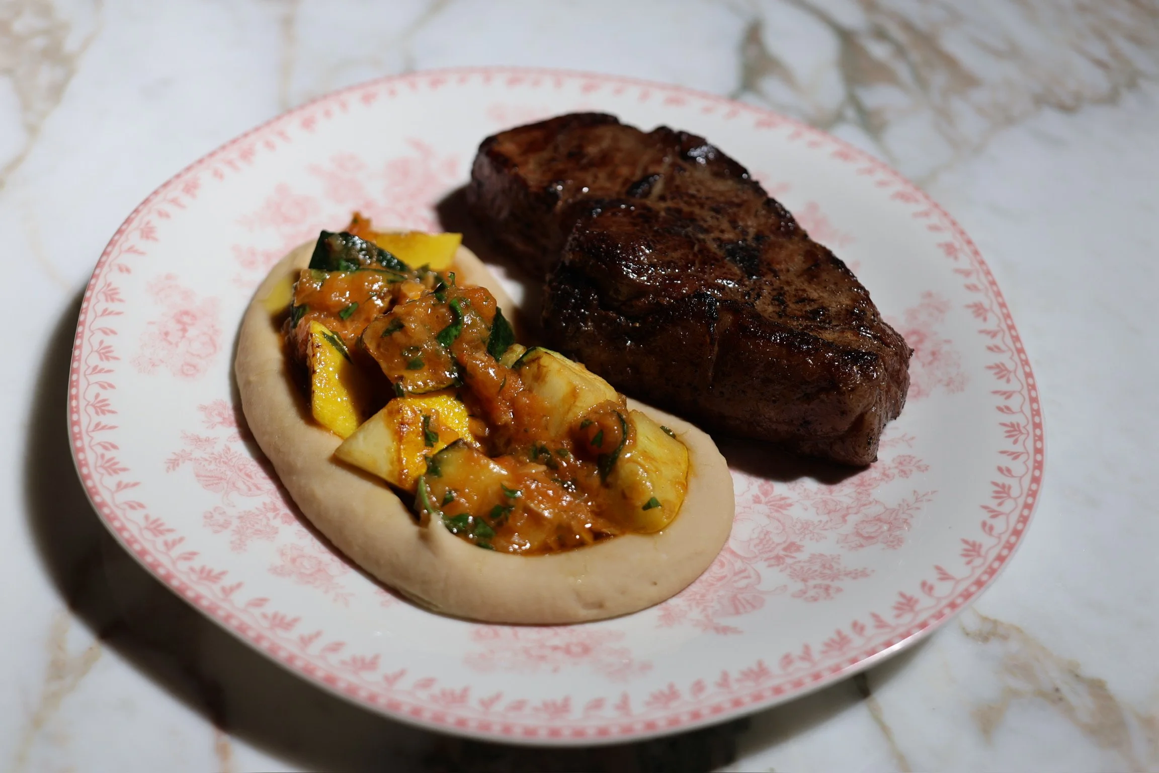 our daily aged STEAK cut from berry beef with cannellini bean puree, summer squashes & tomato conserva