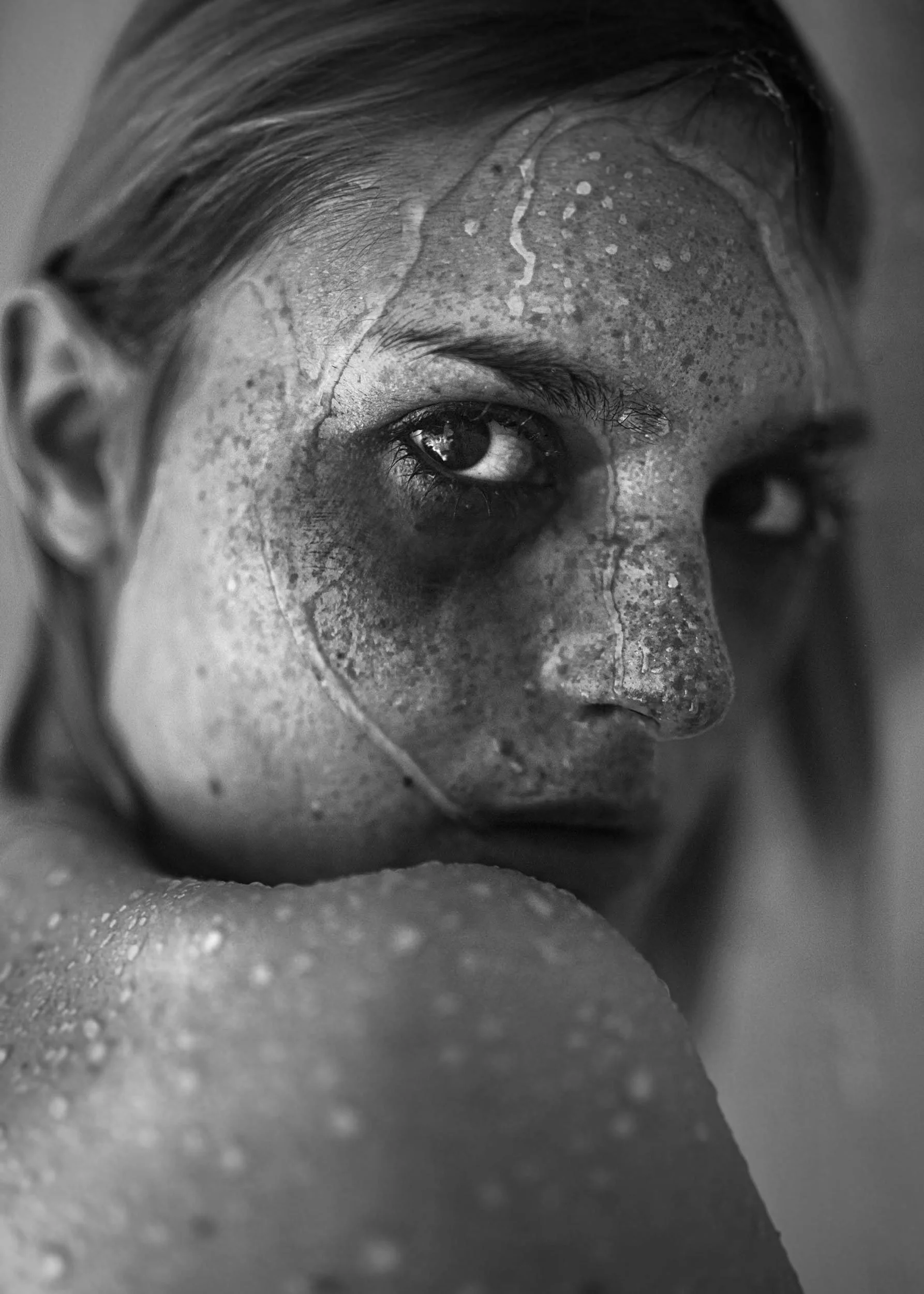 Catarina Correia. Close-up black and white photo of a human face, focusing on the eye and forehead area, with textured and detailed skin.