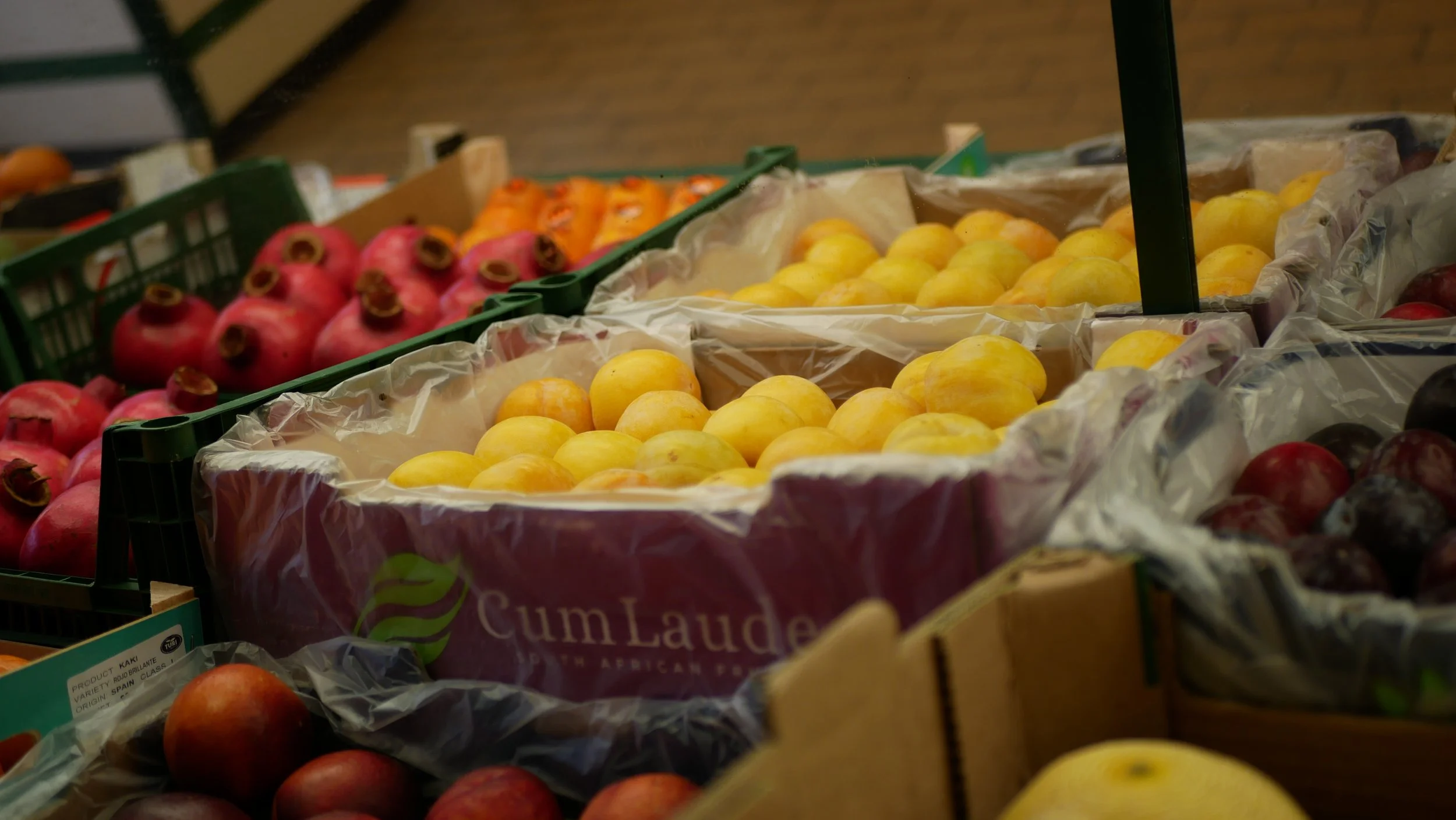 Close-up of fresh apples in crates at a market stall.