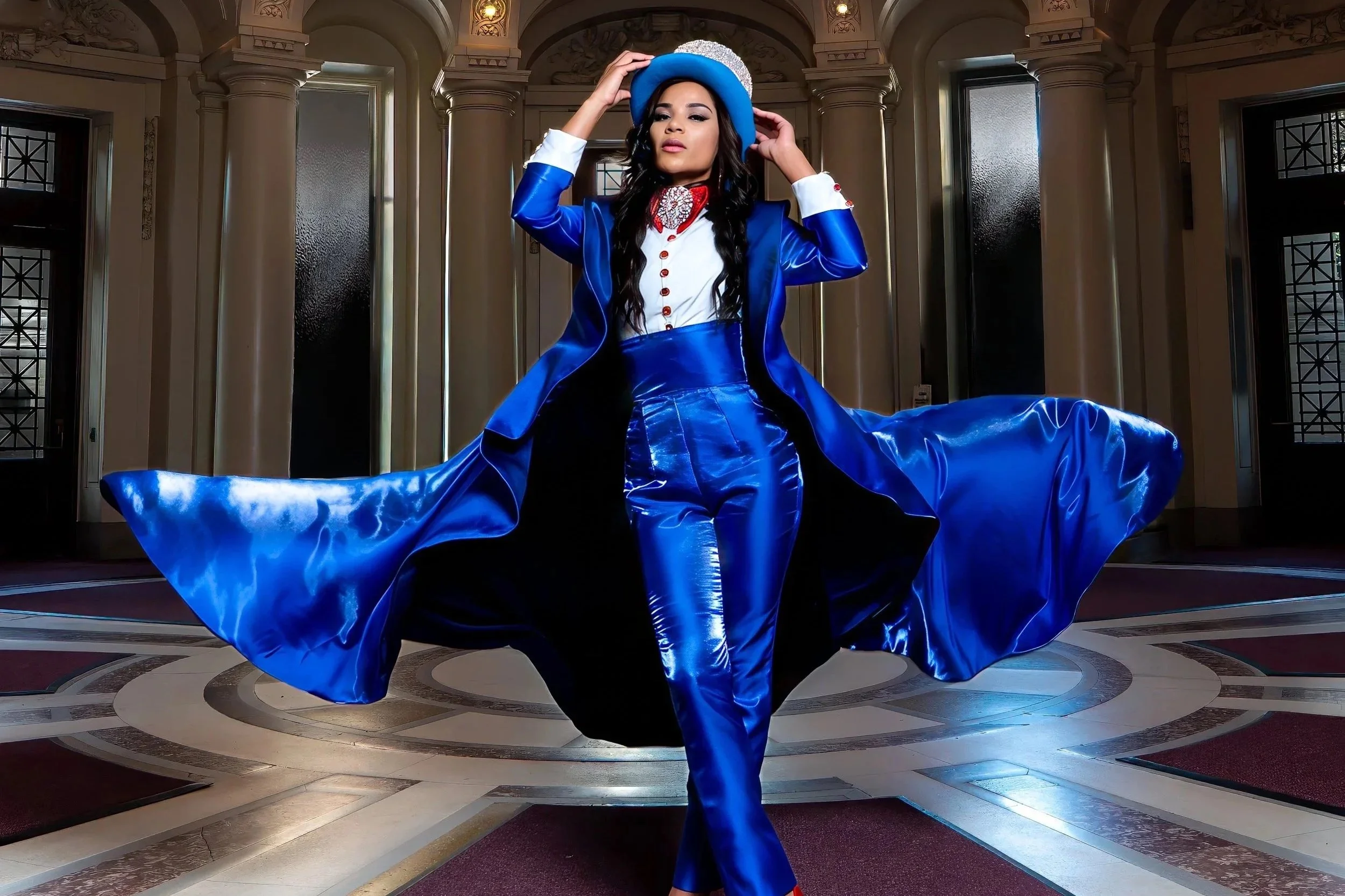 Editorial fashion portrait photographed inside Yale Memorial Hall featuring a model in a royal blue couture suit with dramatic architectural lighting.