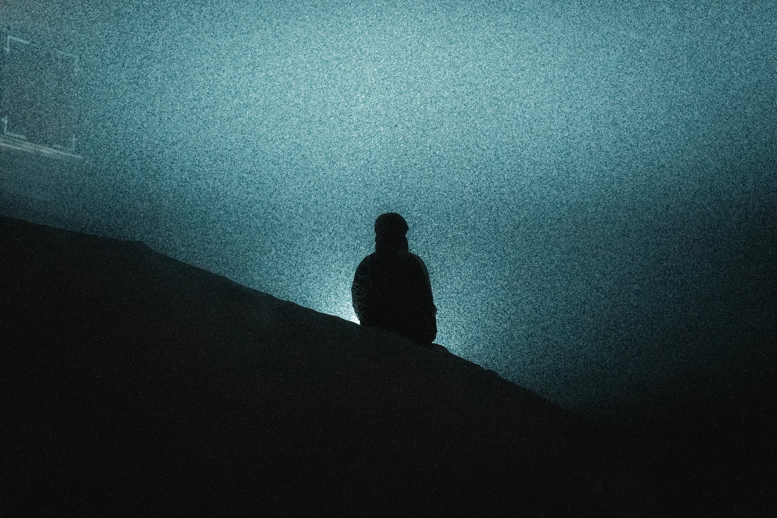 Big Air Ski judge watching the slope at the Whitestyle Open Murren at night under the lights in heavy snowfall